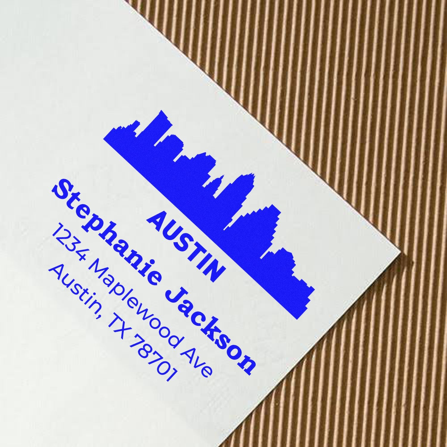 Custom rubber address stamp for Stephanie Jackson in Austin, TX, with skyline logo and personalized contact details.