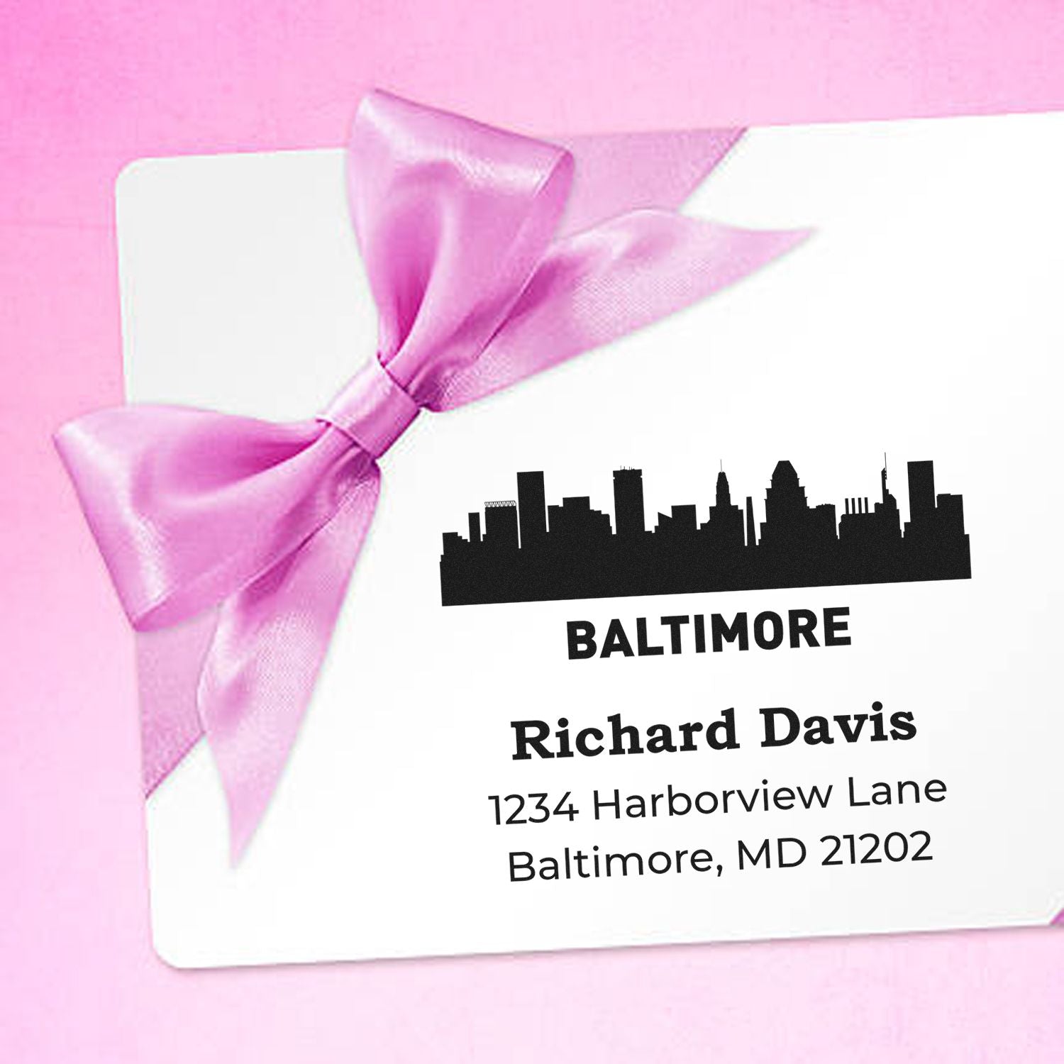 Custom Baltimore rubber stamp return address for Richard Davis, featuring skyline design on a white envelope with pink ribbon.