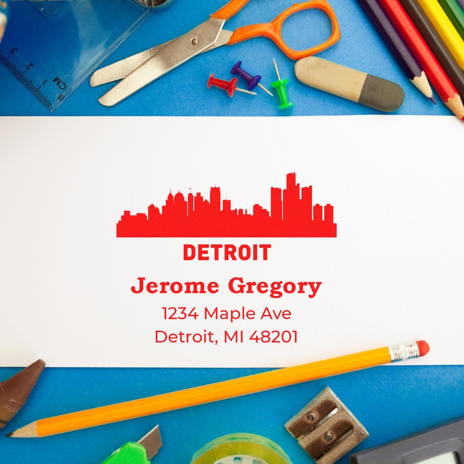 Custom Detroit address rubber stamp with skyline design, name, street address, and ZIP on stationery.