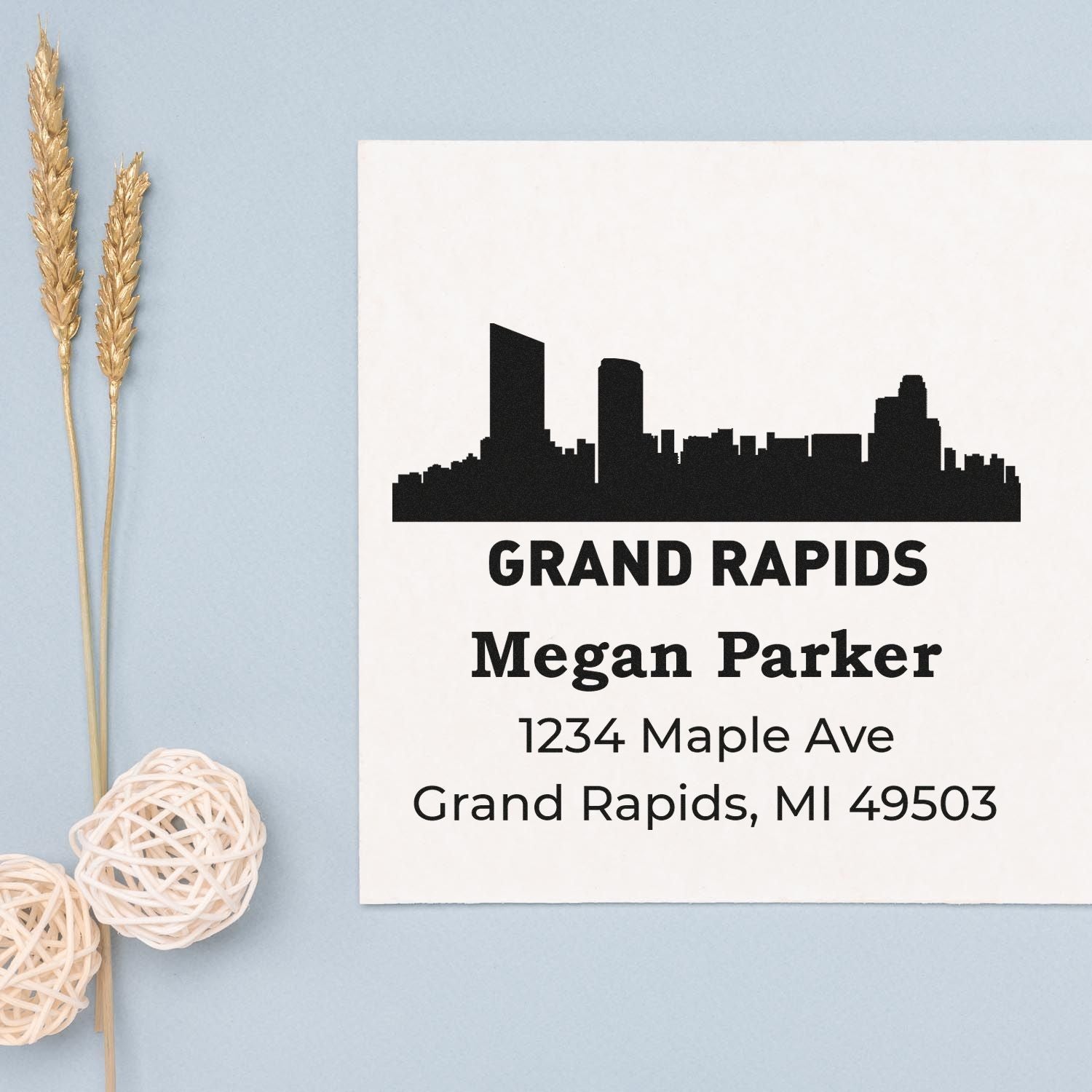 Custom Grand Rapids address rubber stamp with skyline, Megan Parker name, and 1234 Maple Ave, Grand Rapids, MI 49503.