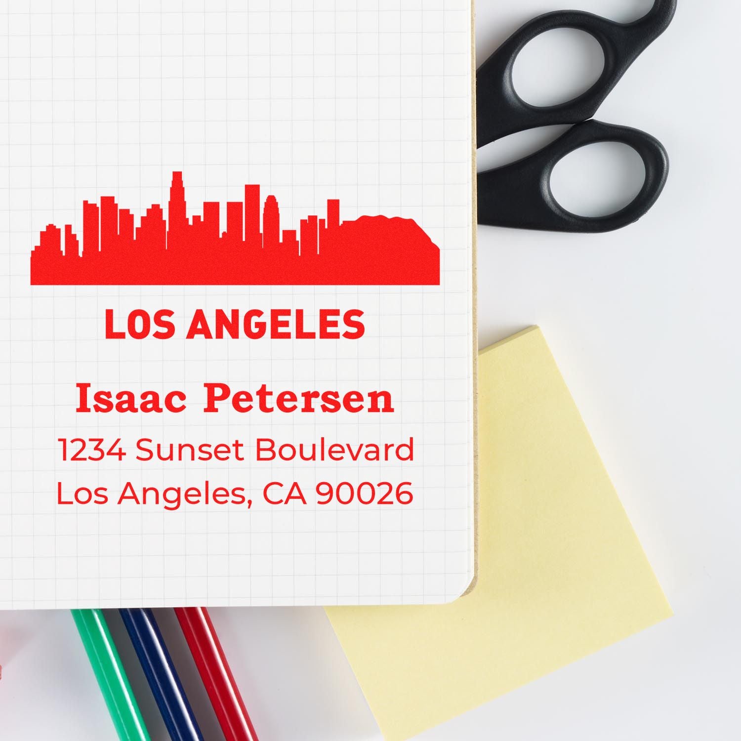 Custom rubber address stamp with Los Angeles skyline, name, and mailing address for business branding and envelopes.