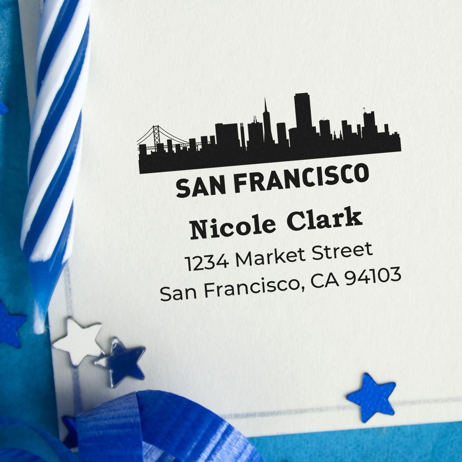 Custom rubber address stamp with San Francisco skyline, Nicole Clark name, and return address for personalized mailing.