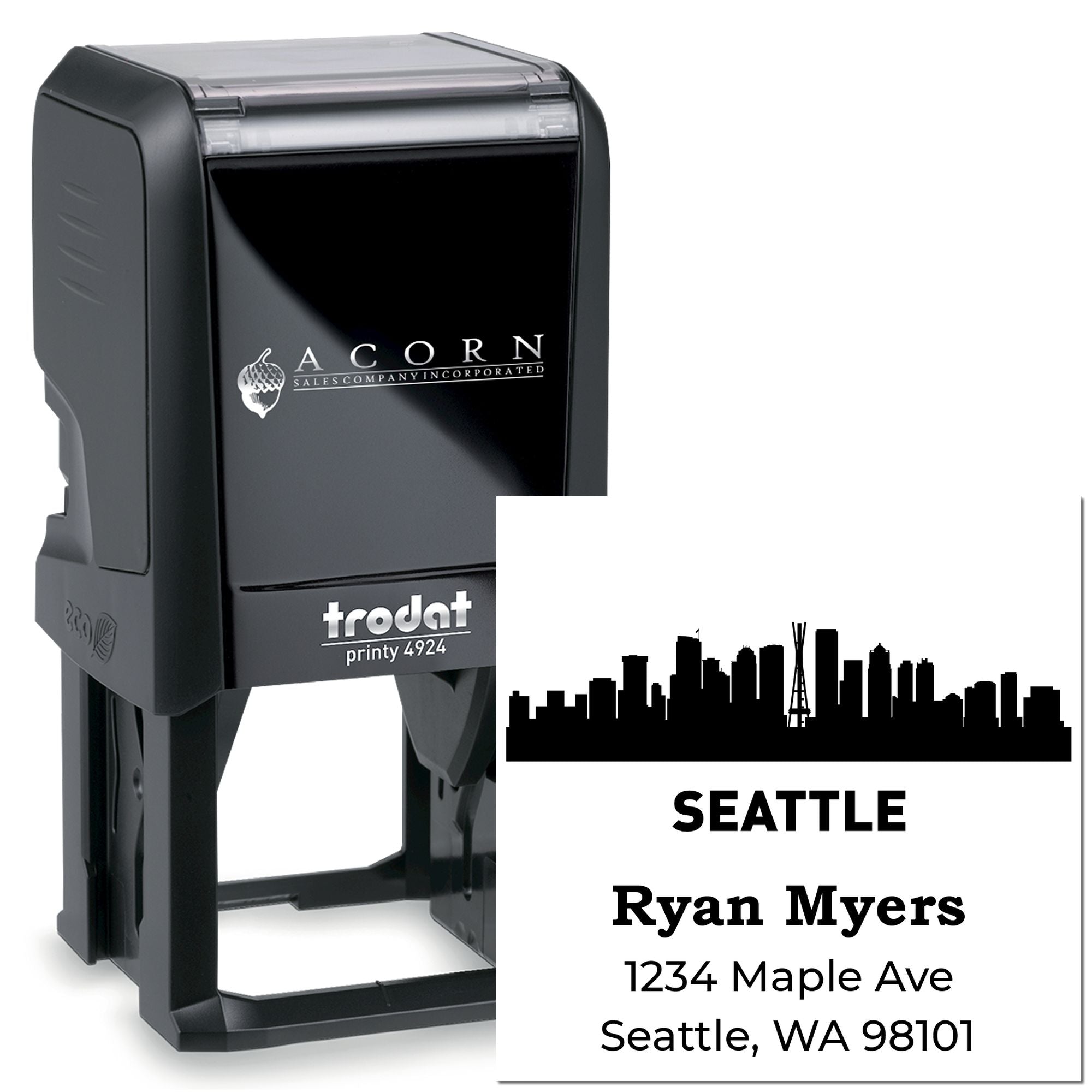 Custom self-inking rubber address stamp with Seattle skyline logo, name, and address for business mailings.