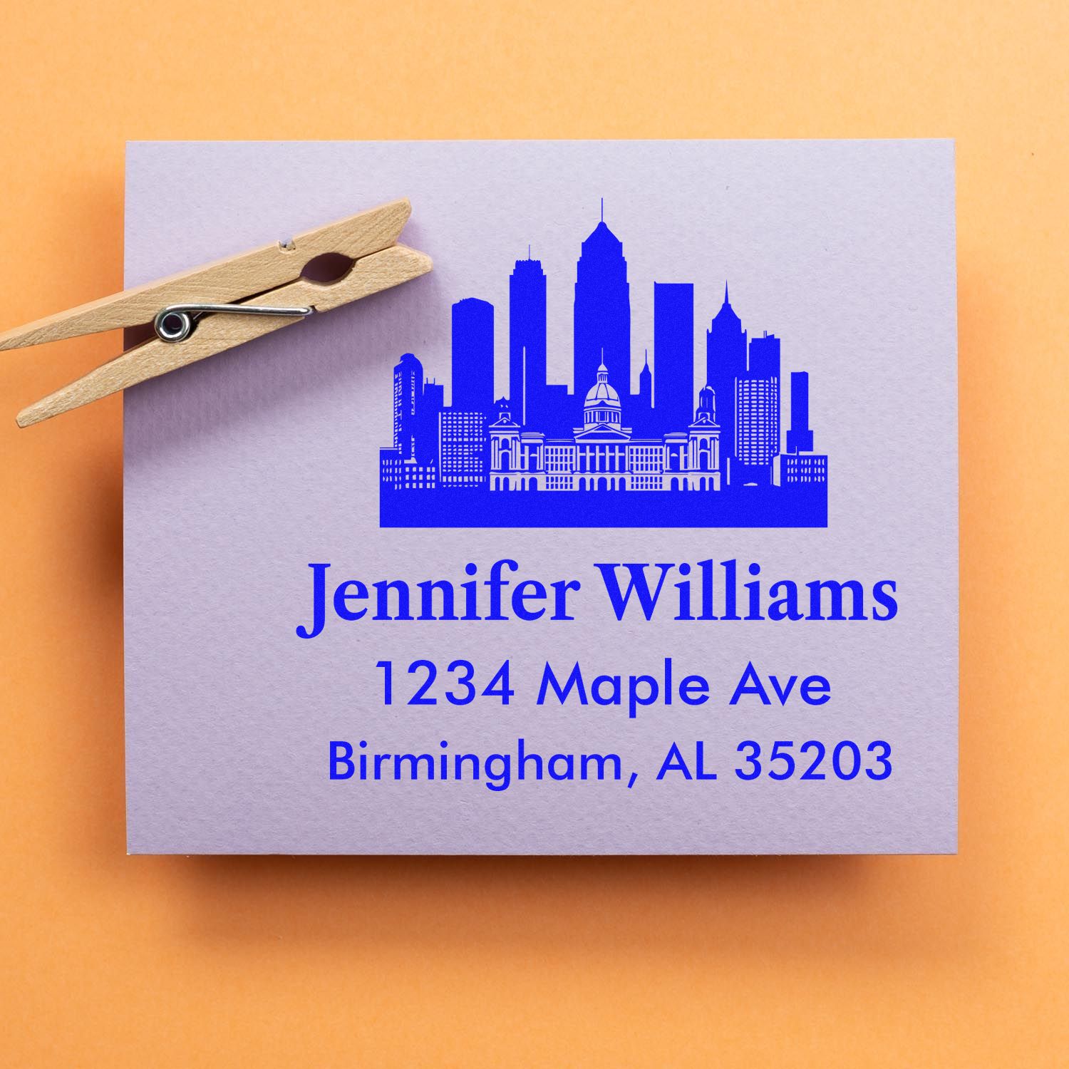 Custom rubber stamp design with Birmingham skyline and return address for Jennifer Williams, 1234 Maple Ave, AL 35203.