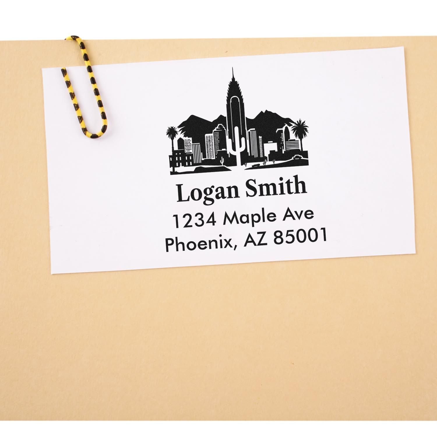 Custom return address rubber stamp with Phoenix skyline design, featuring Logan Smith, 1234 Maple Ave, Phoenix, AZ 85001