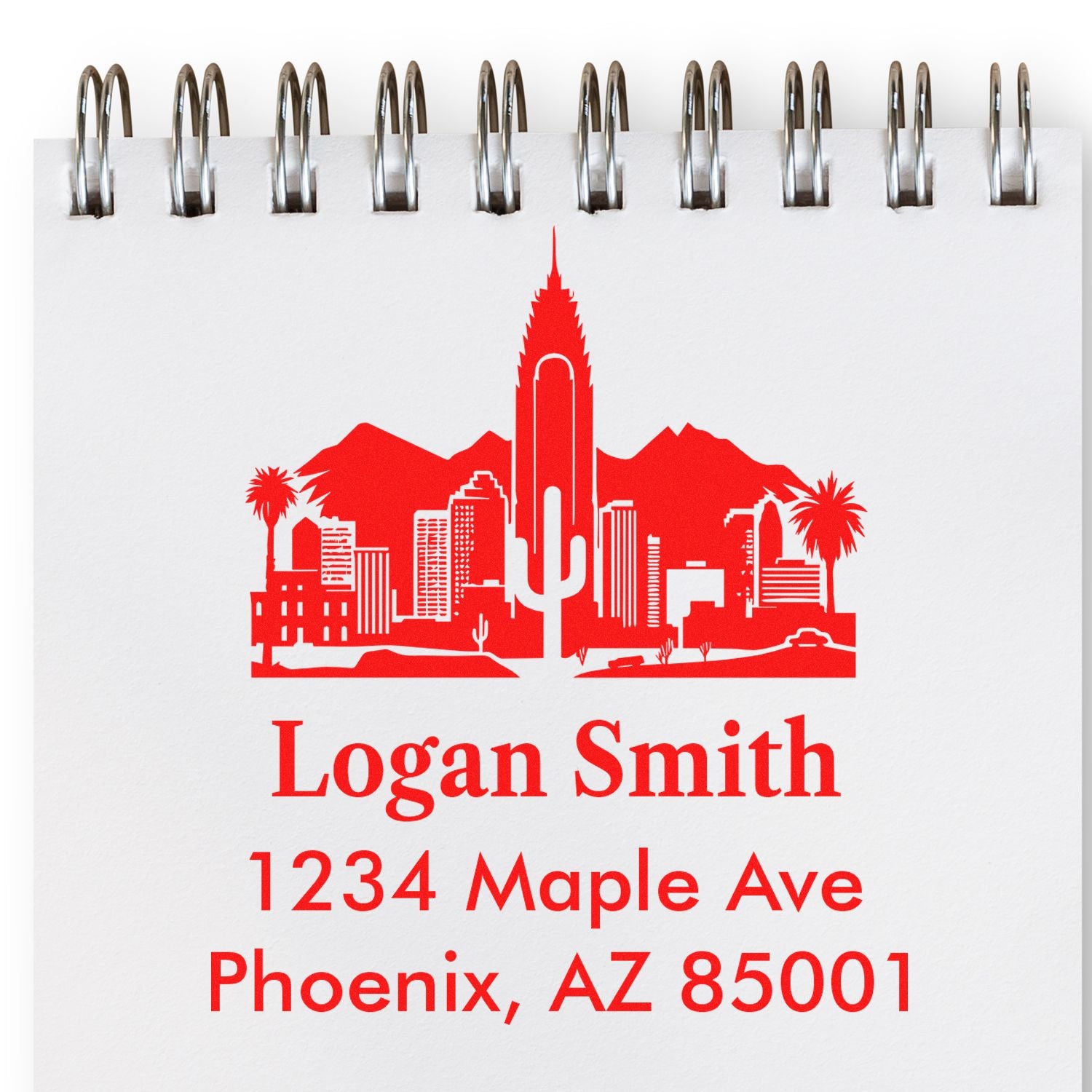 Custom address rubber stamp with Phoenix, AZ skyline and cactus design for Logan Smith, 1234 Maple Ave, Phoenix, AZ 85001