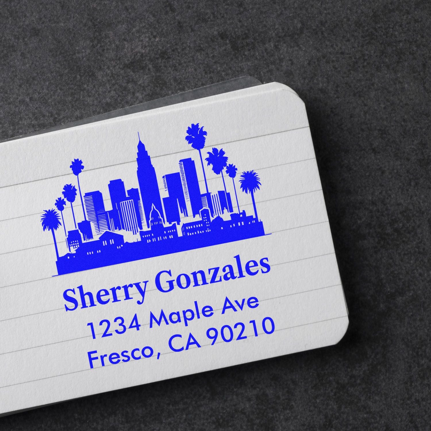 Custom return address rubber stamp with city skyline and palm trees for Sherry Gonzales, Fresno, CA 90210.