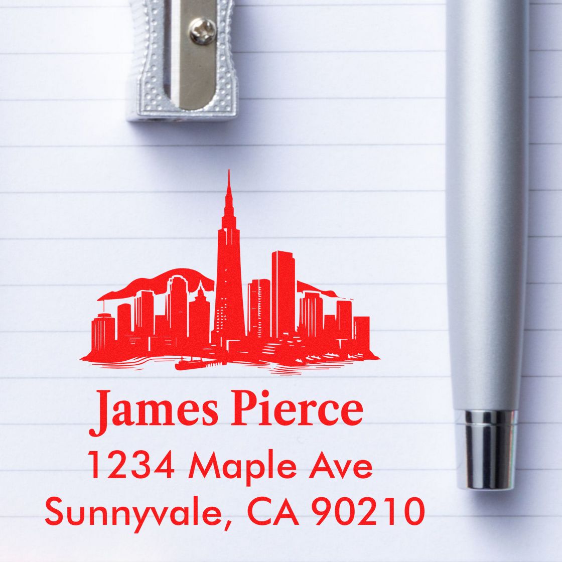 Custom rubber return address stamp with skyline design, James Pierce, 1234 Maple Ave, Sunnyvale, CA 90210.
