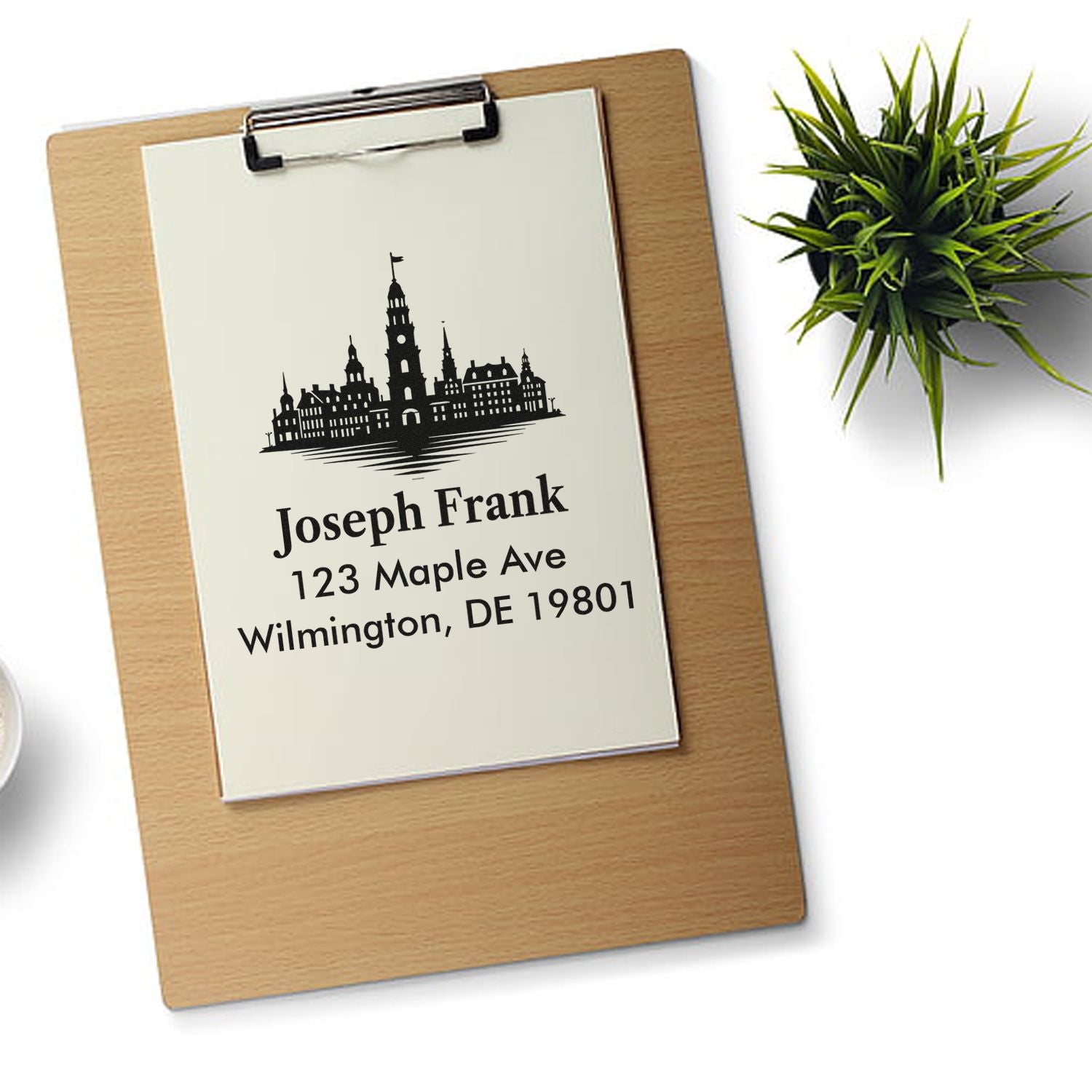 Custom address rubber stamp with skyline design and return address for Joseph Frank, 123 Maple Ave, Wilmington, DE 19801.