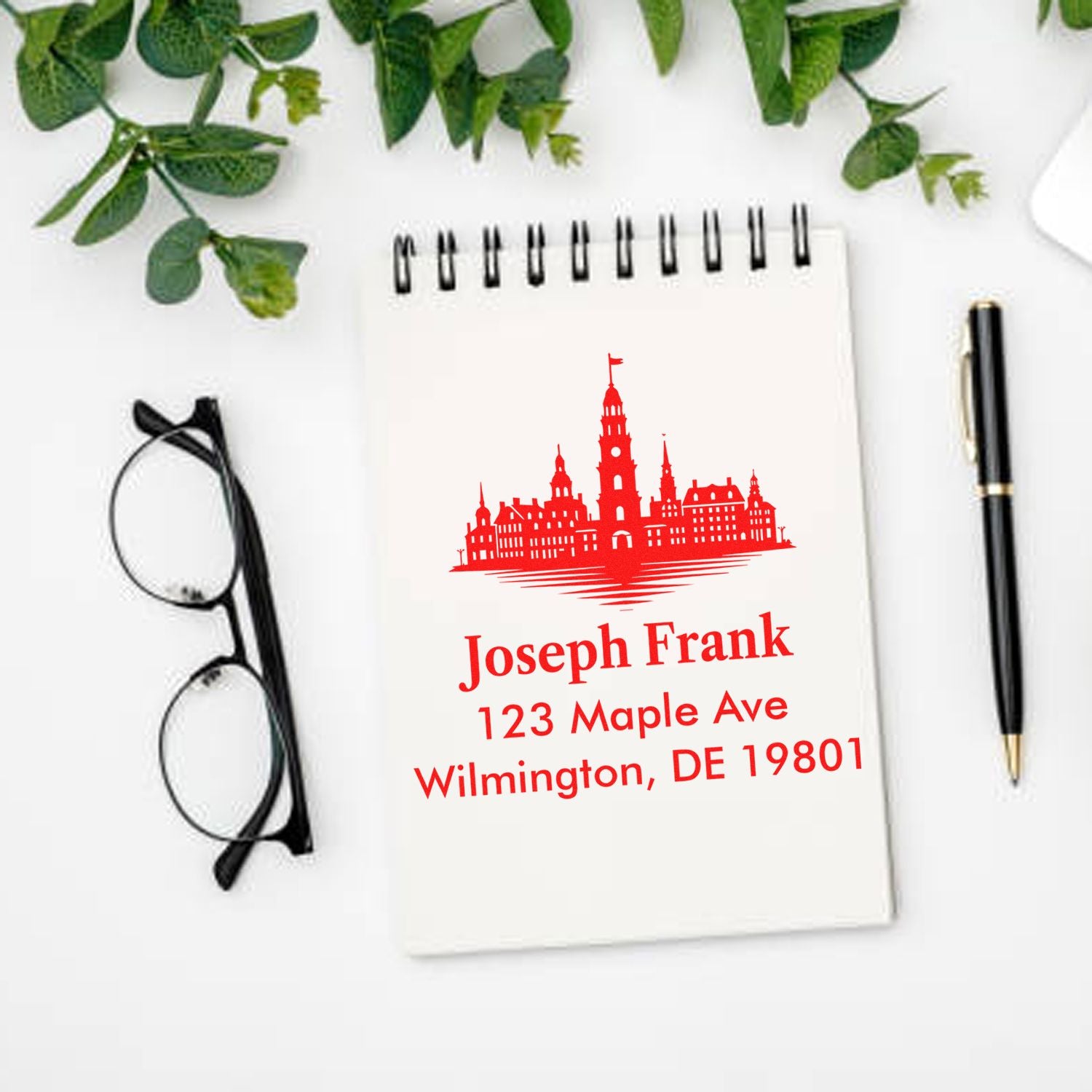 Custom return address rubber stamp with city skyline for Joseph Frank, 123 Maple Ave, Wilmington, DE 19801.