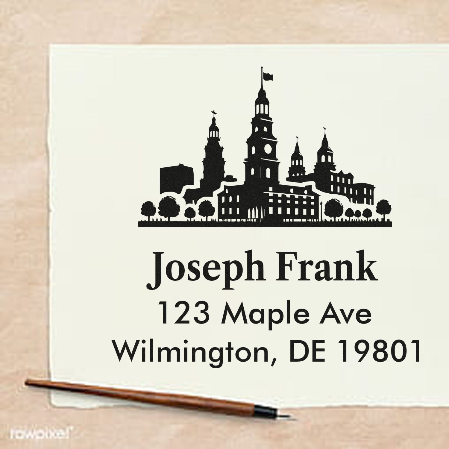 Custom address rubber stamp with skyline design for Joseph Frank, 123 Maple Ave, Wilmington, DE 19801.