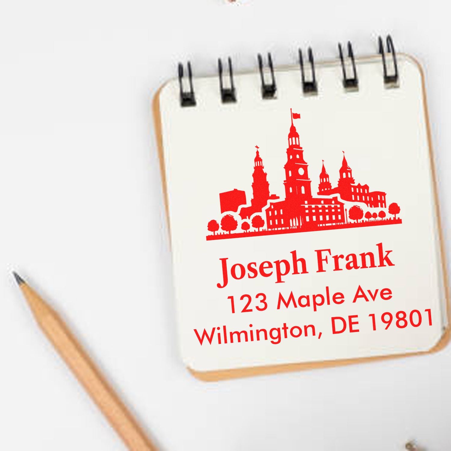 Custom rubber address stamp with skyline design and Joseph Frank Wilmington, DE return address.