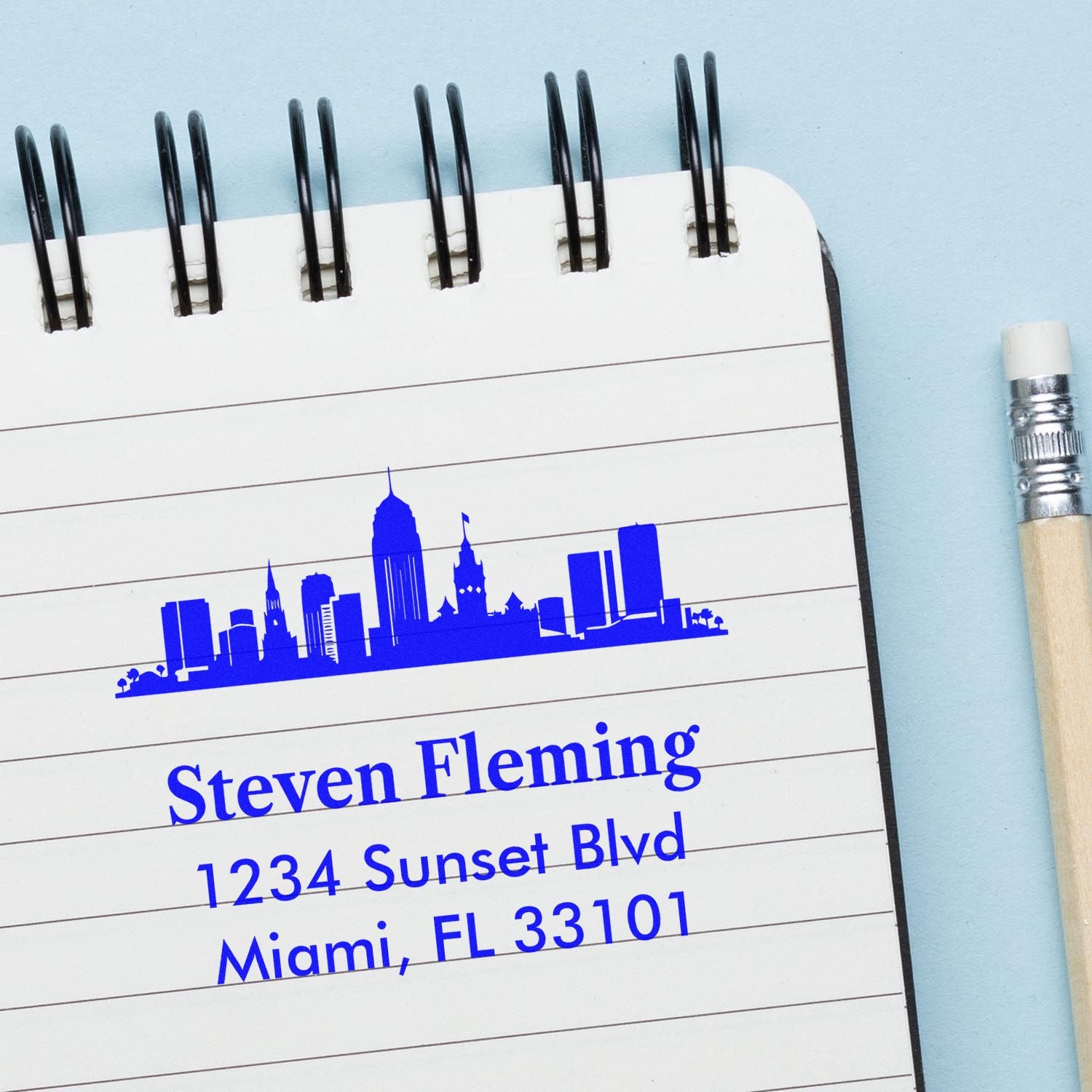 Personalized rubber address stamp with skyline logo and Miami, FL return address printed on a notepad