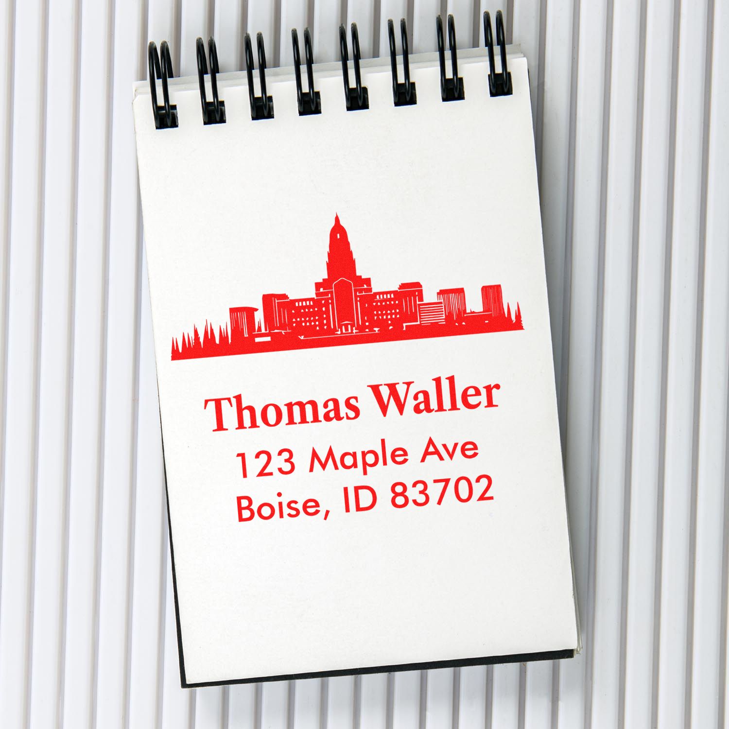 Custom address rubber stamp with Boise skyline, personalized name, street address, and ZIP code for mailing.