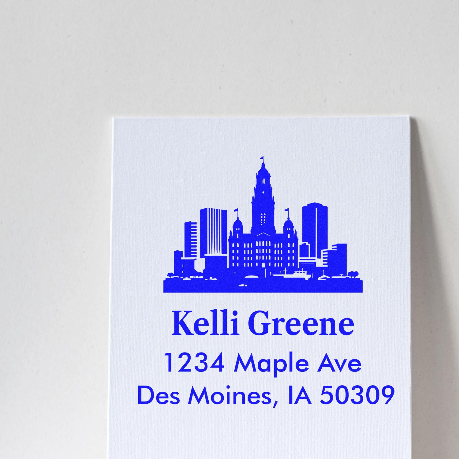Custom address rubber stamp with Des Moines skyline for Kelli Greene, 1234 Maple Ave, Des Moines, IA 50309.