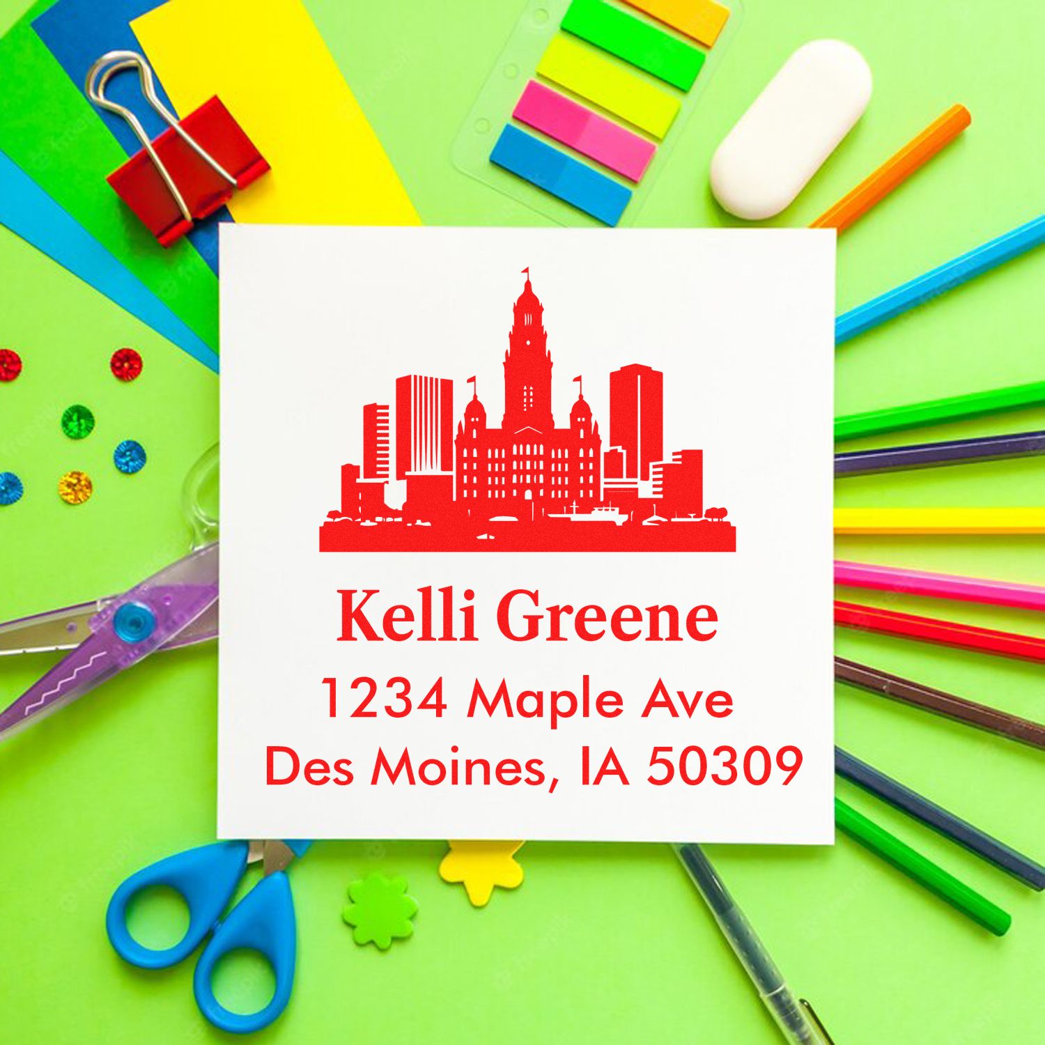 Custom address rubber stamp with city skyline logo for Kelli Greene, 1234 Maple Ave, Des Moines, IA 50309