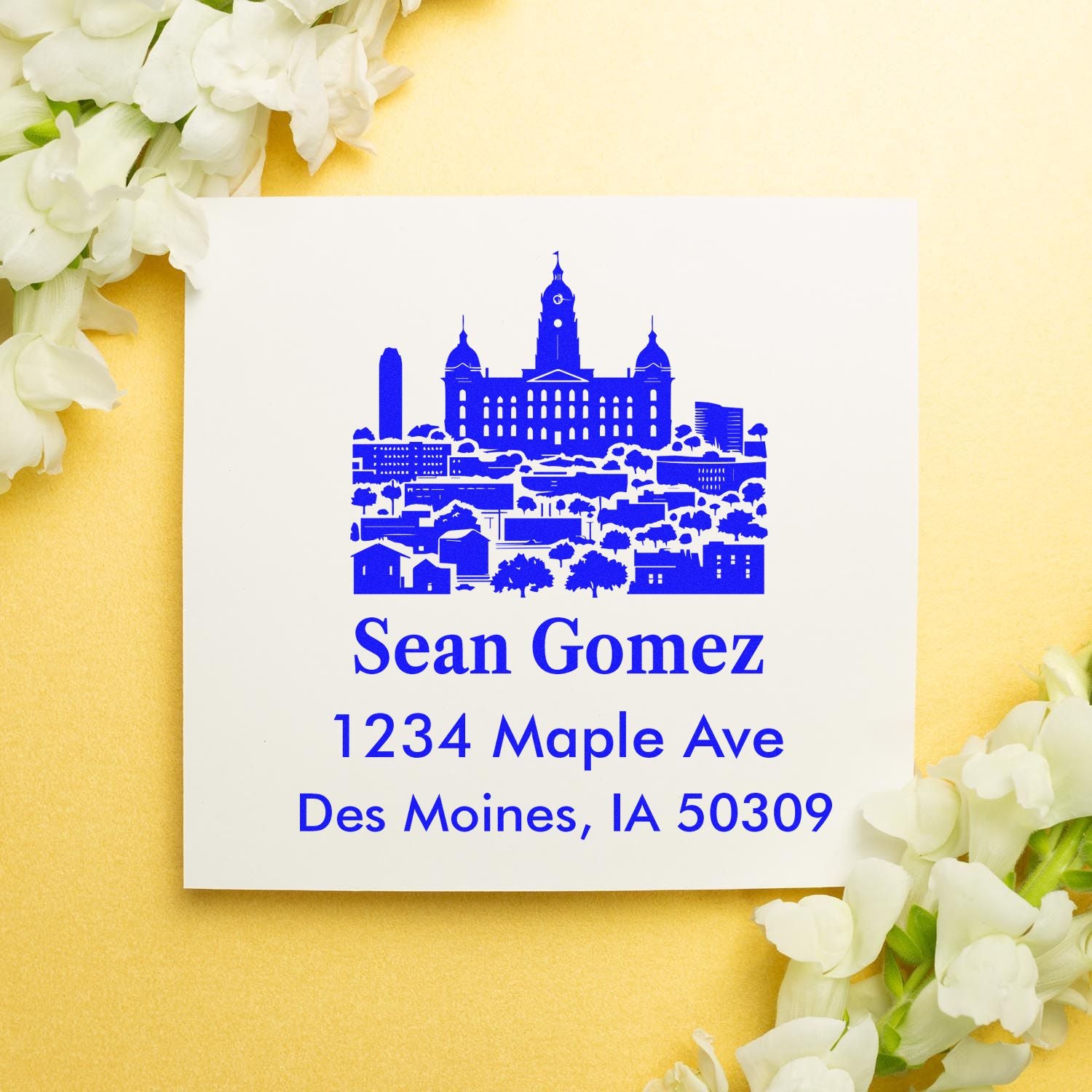 Personalized rubber return address stamp with Des Moines skyline, Sean Gomez, and 1234 Maple Ave, Des Moines, IA 50309.