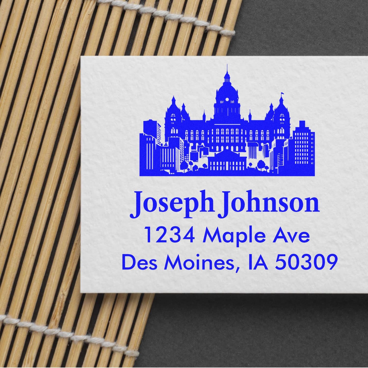 Personalized rubber return address stamp with city skyline, Joseph Johnson, and Des Moines, IA 50309.