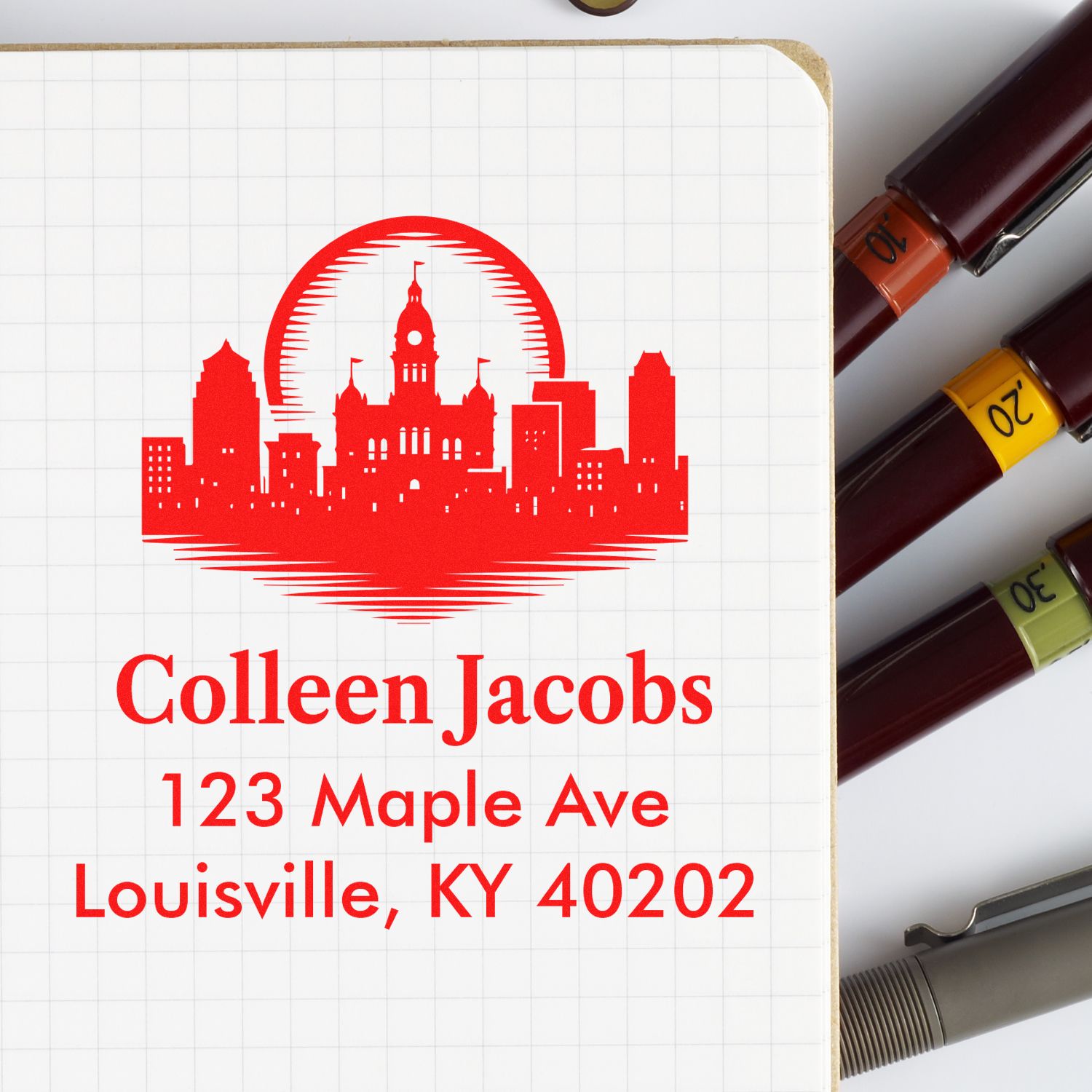 Custom address rubber stamp with Louisville skyline logo for Colleen Jacobs, 123 Maple Ave, Louisville, KY 40202