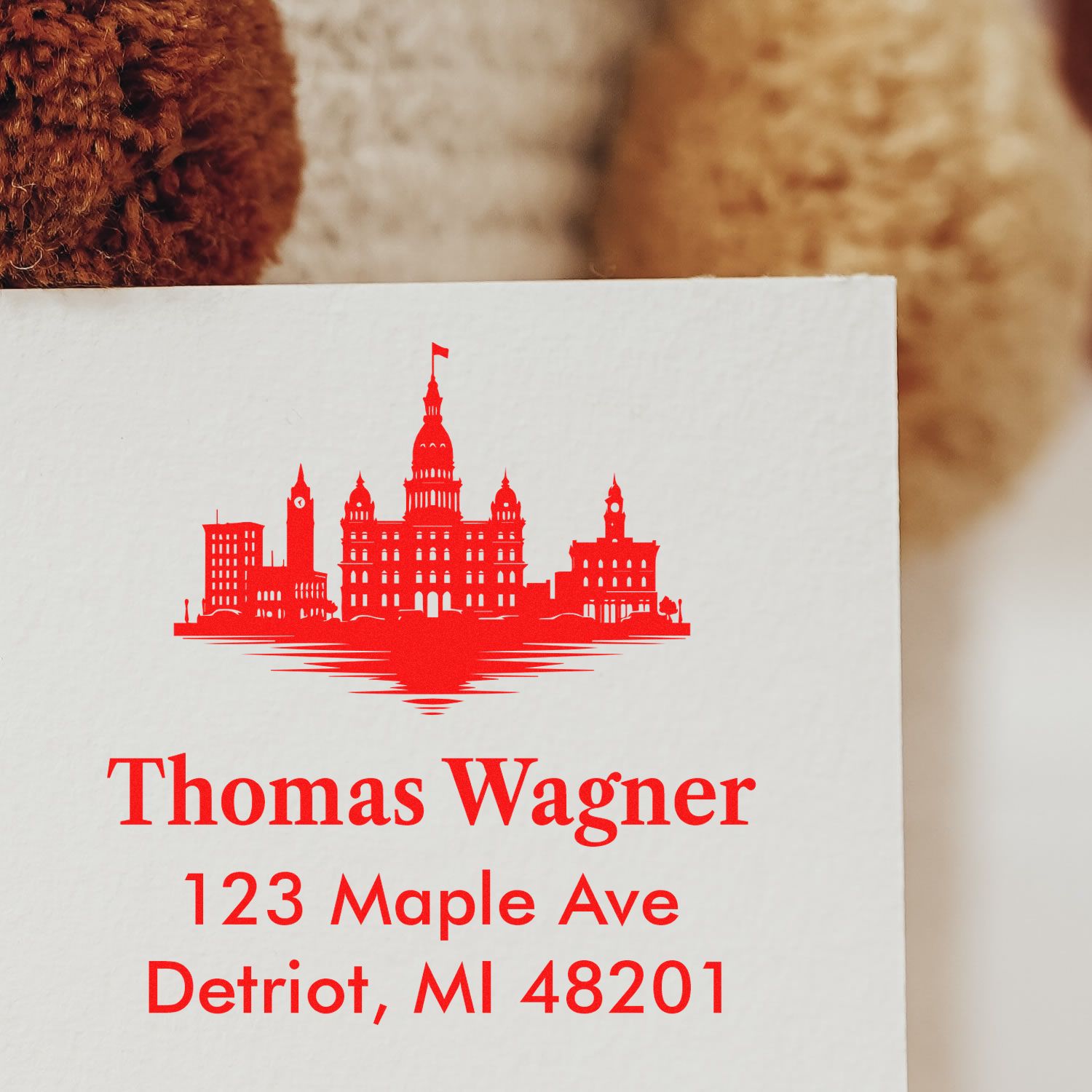 Custom rubber address stamp with Detroit skyline logo for Thomas Wagner, 123 Maple Ave, Detroit, MI 48201.