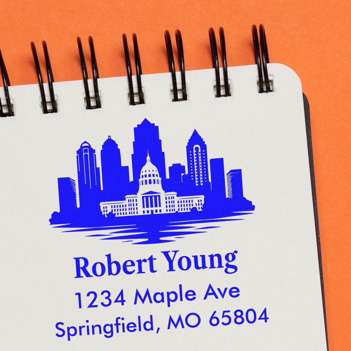 Custom return address rubber stamp with city skyline for Robert Young, 1234 Maple Ave, Springfield, MO 65804.