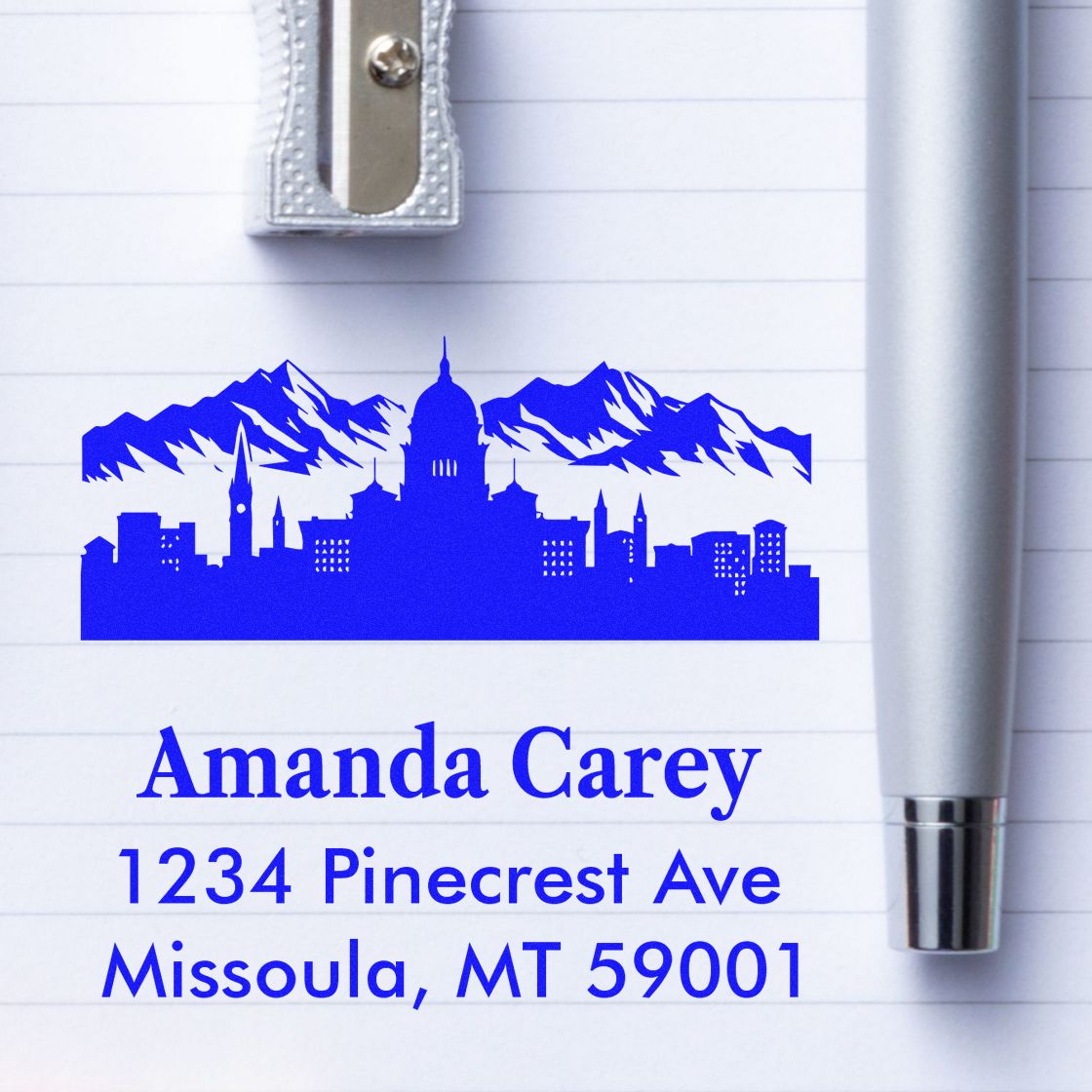 Self-inking return address rubber stamp with mountain skyline, Amanda Carey, 1234 Pinecrest Ave, Missoula, MT 59001