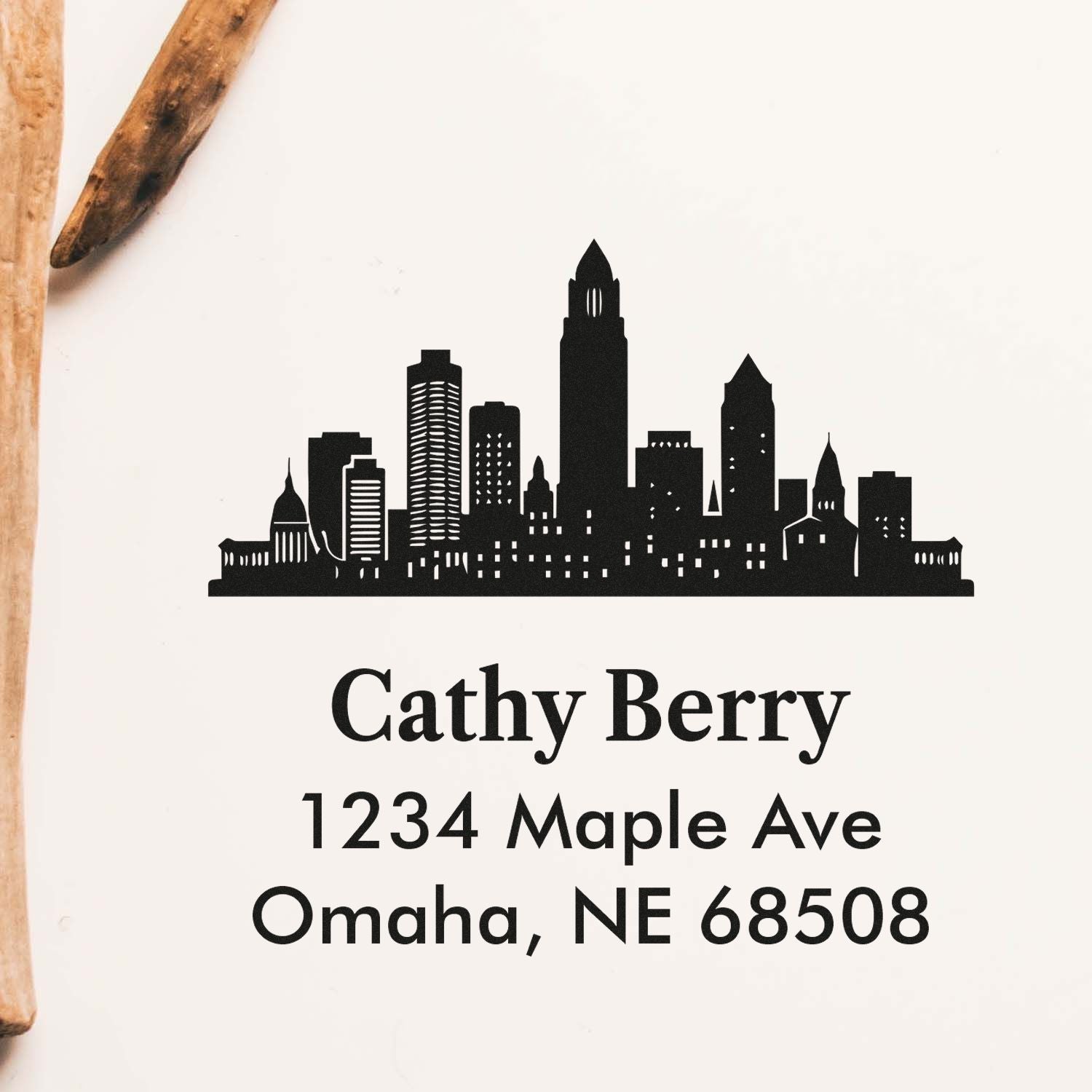 Custom rubber return address stamp with Omaha skyline, Cathy Berry, and 1234 Maple Ave, Omaha, NE 68508.
