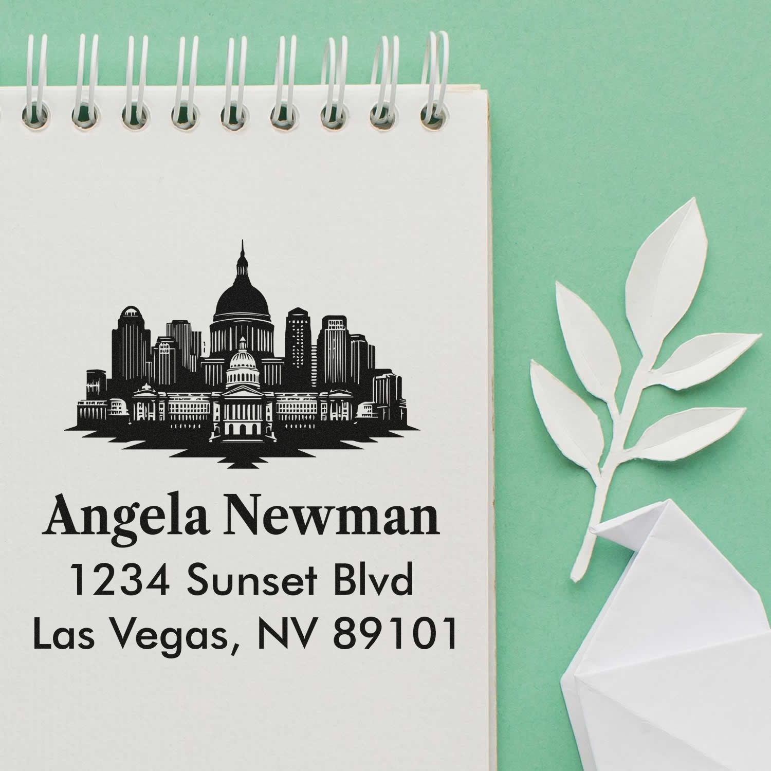 Custom rubber return address stamp with Las Vegas skyline for Angela Newman, 1234 Sunset Blvd, NV 89101.