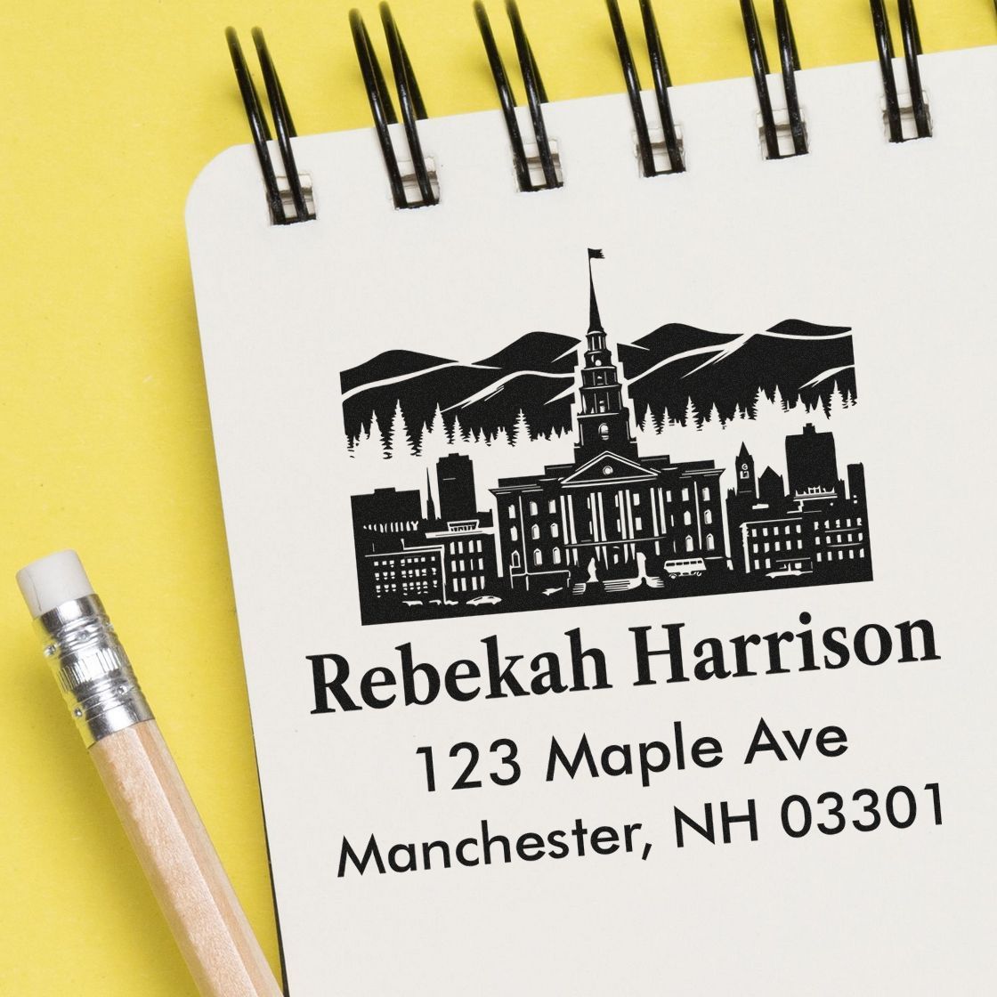 Custom return address rubber stamp with skyline design for Rebekah Harrison, 123 Maple Ave, Manchester, NH 03301.