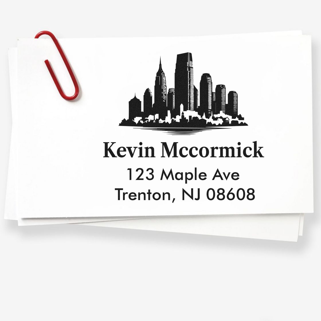 Custom return address rubber stamp with city skyline logo for Kevin Mccormick, 123 Maple Ave, Trenton, NJ 08608.