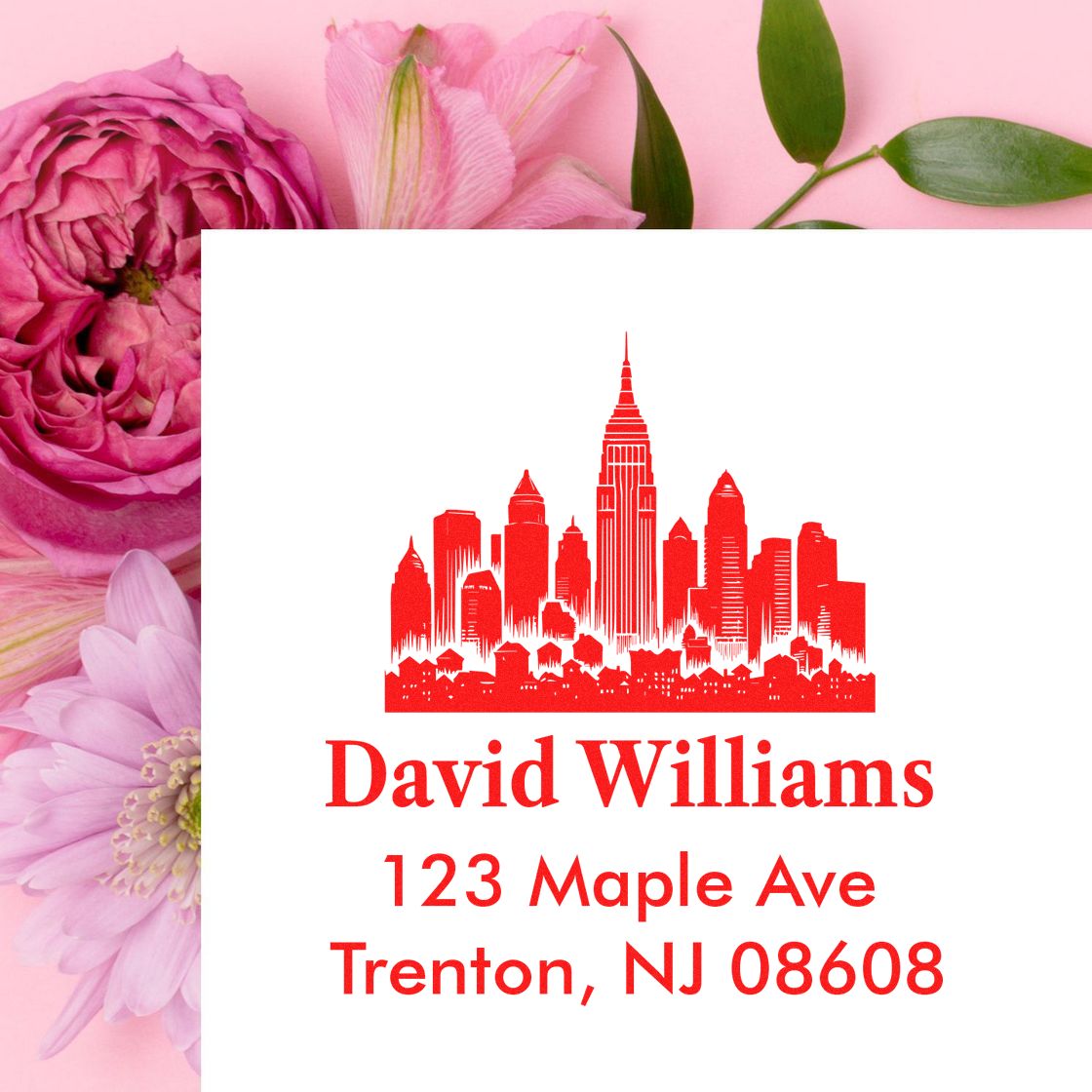 Custom return address rubber stamp with red city skyline, David Williams, 123 Maple Ave, Trenton, NJ 08608.