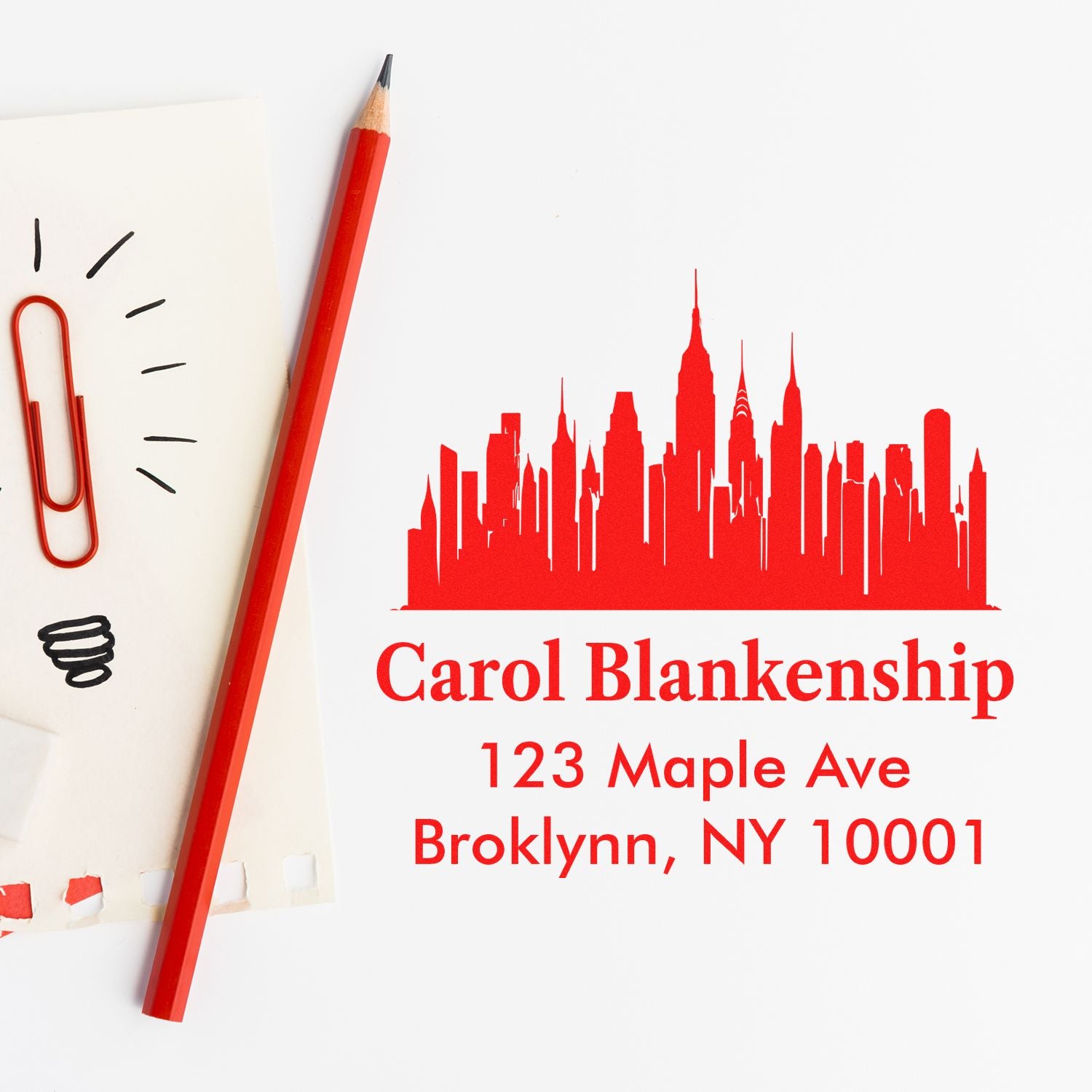 Custom address rubber stamp with skyline design for personalized envelopes and business stationery.