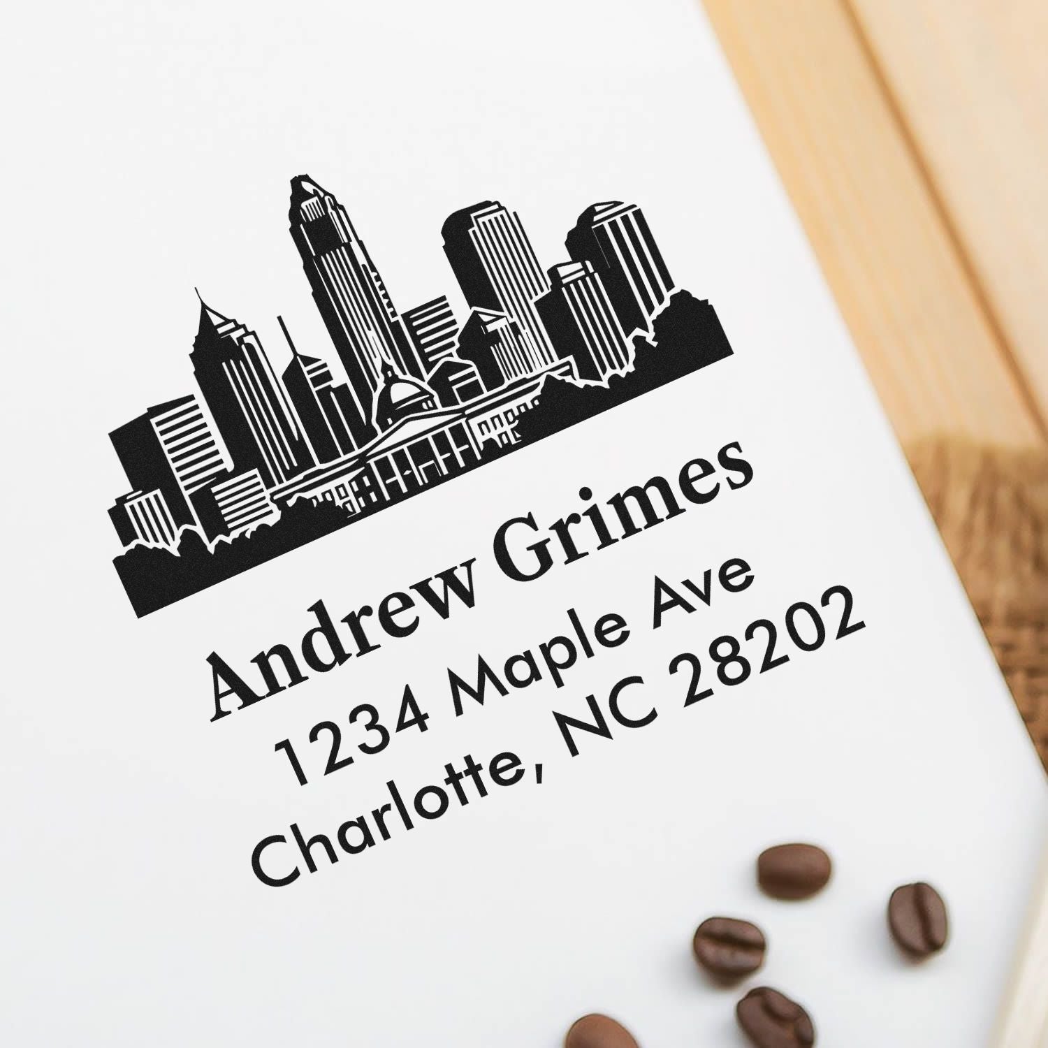 Personalized rubber address stamp with Charlotte skyline for Andrew Grimes, 1234 Maple Ave, Charlotte, NC 28202.