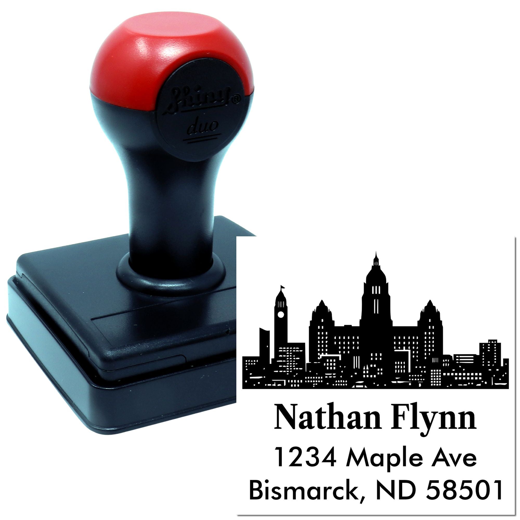 Custom self-inking rubber address stamp with skyline design and Nathan Flynn, Bismarck ND return address
