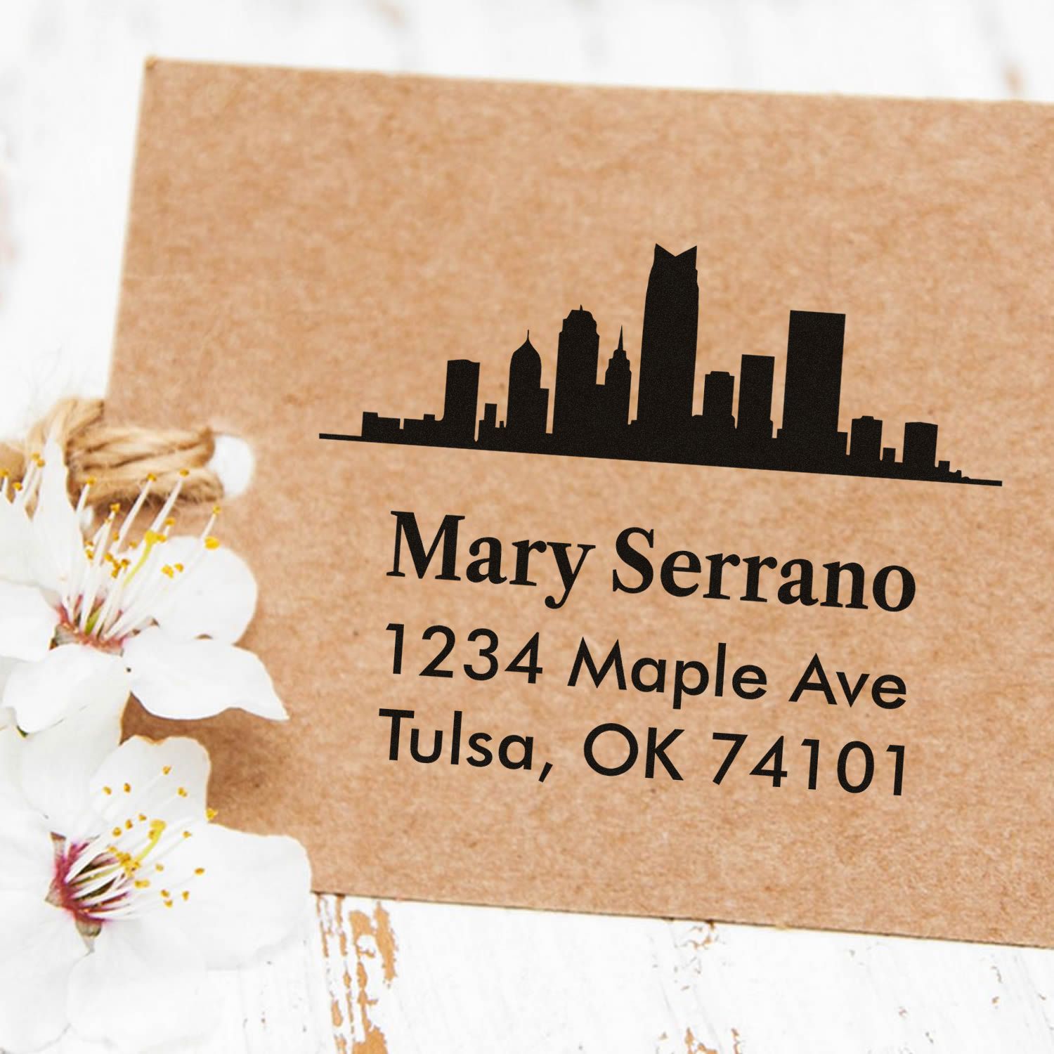 Custom skyline address rubber stamp with name, street address, and city for personalized stationery and packaging.