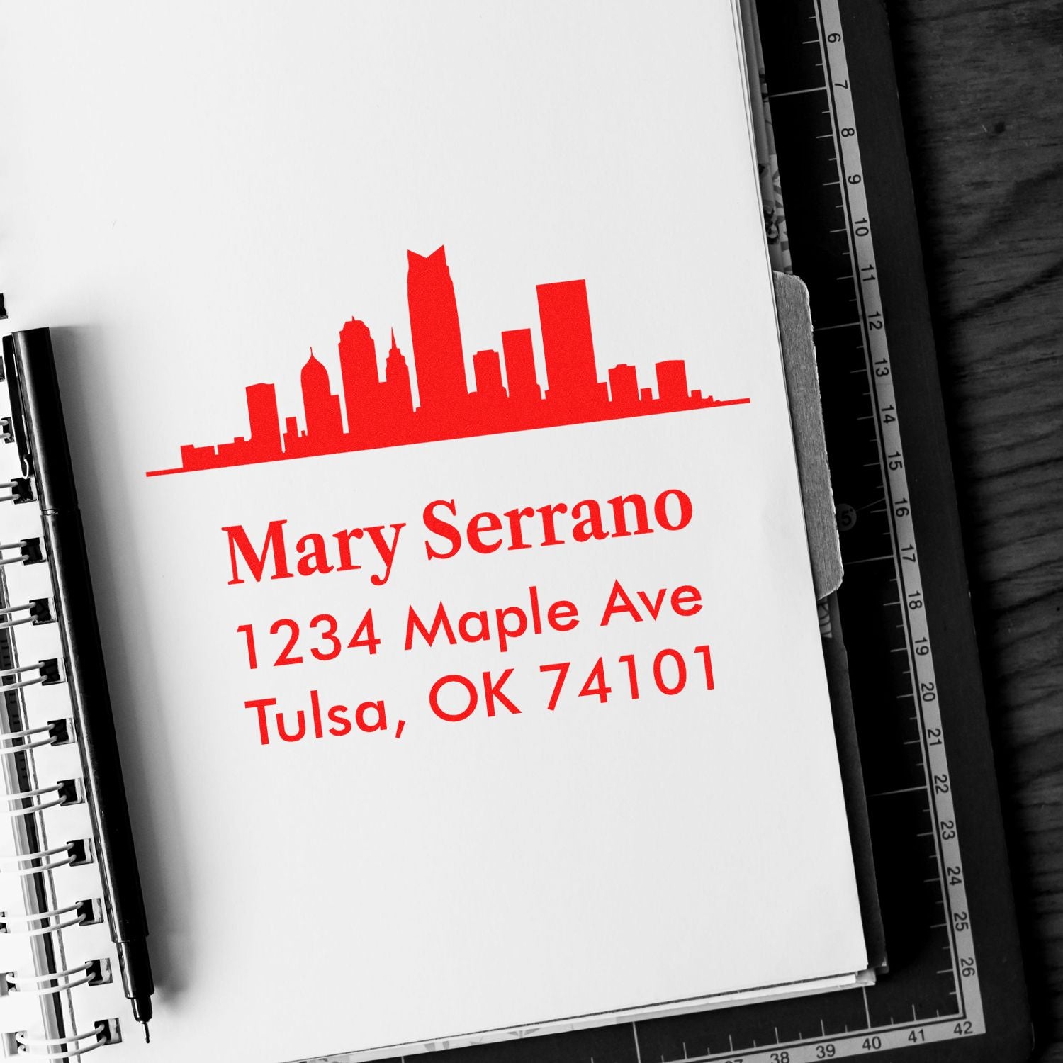 Custom rubber address stamp with skyline design and return address for Mary Serrano, Tulsa, OK 74101.