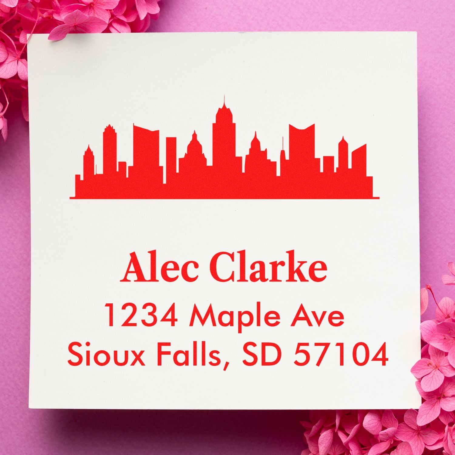 Custom return address rubber stamp with city skyline for Alec Clarke, Sioux Falls, SD 57104.