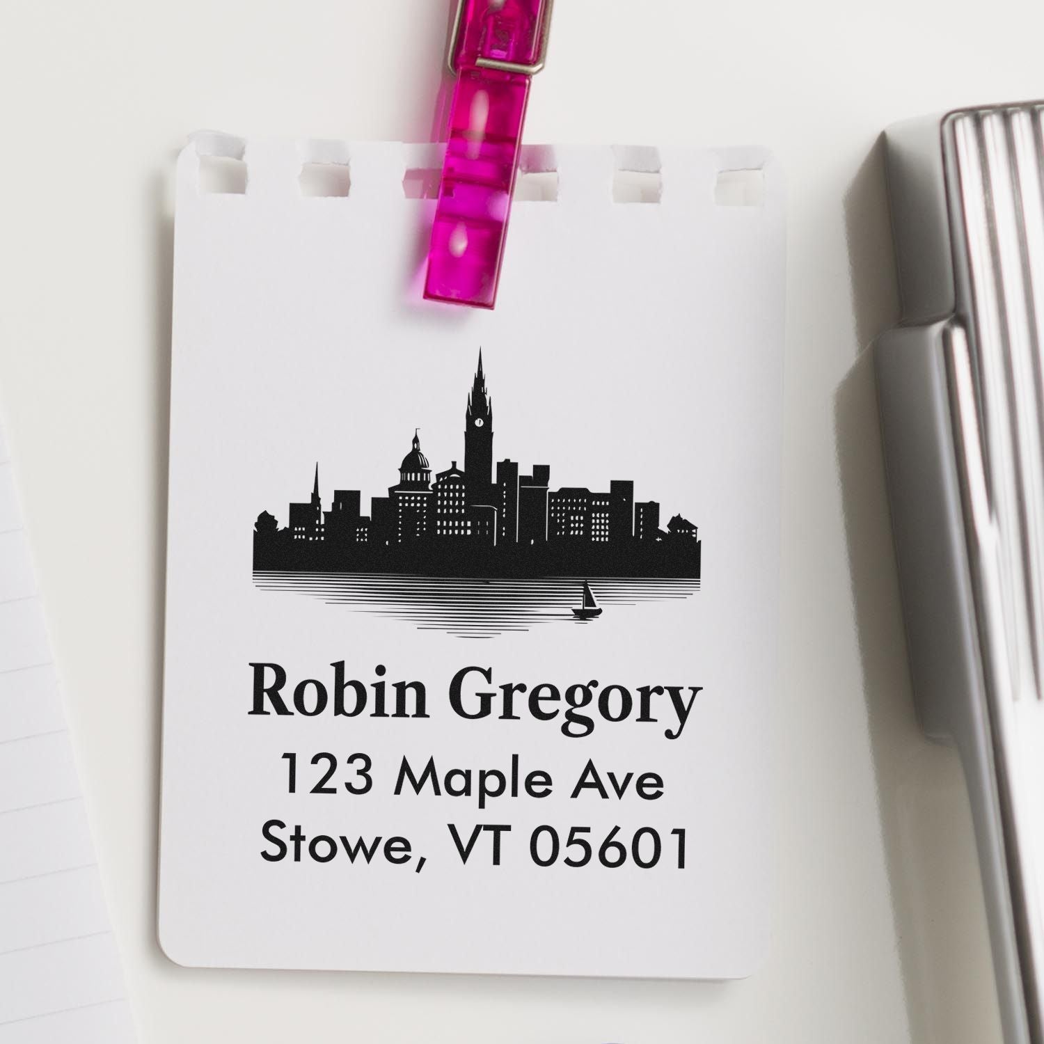Custom address rubber stamp with skyline design for Robin Gregory, 123 Maple Ave, Stowe, VT 05601.