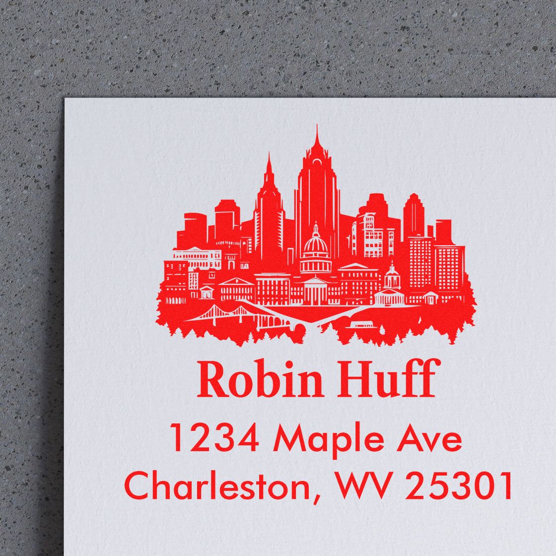 Custom return address rubber stamp with Charleston, WV skyline, Robin Huff, and 1234 Maple Ave for mail and branding.