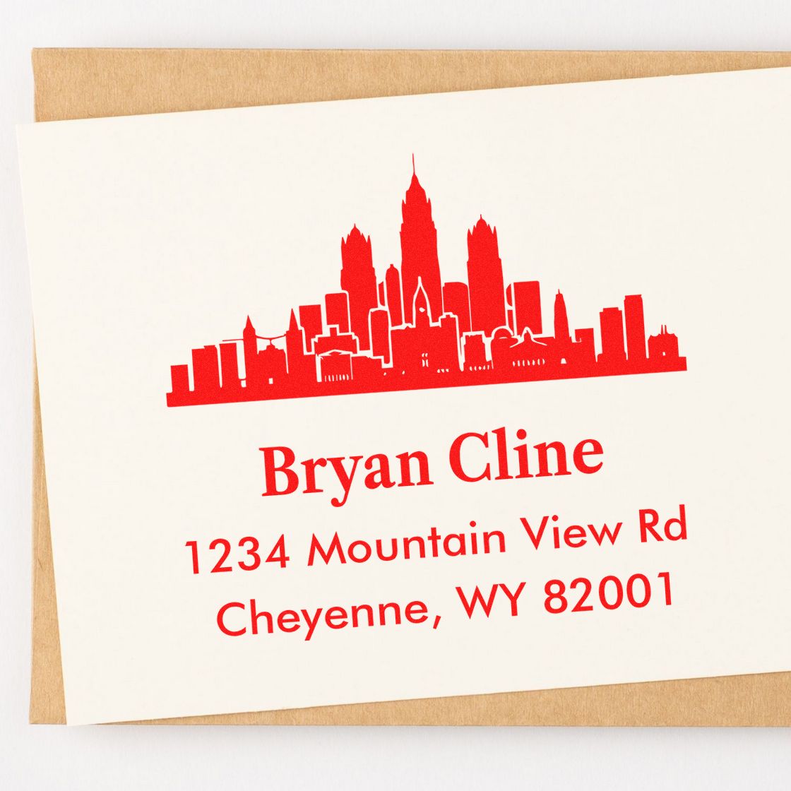 Custom address rubber stamp with skyline design for Bryan Cline, 1234 Mountain View Rd, Cheyenne, WY 82001.