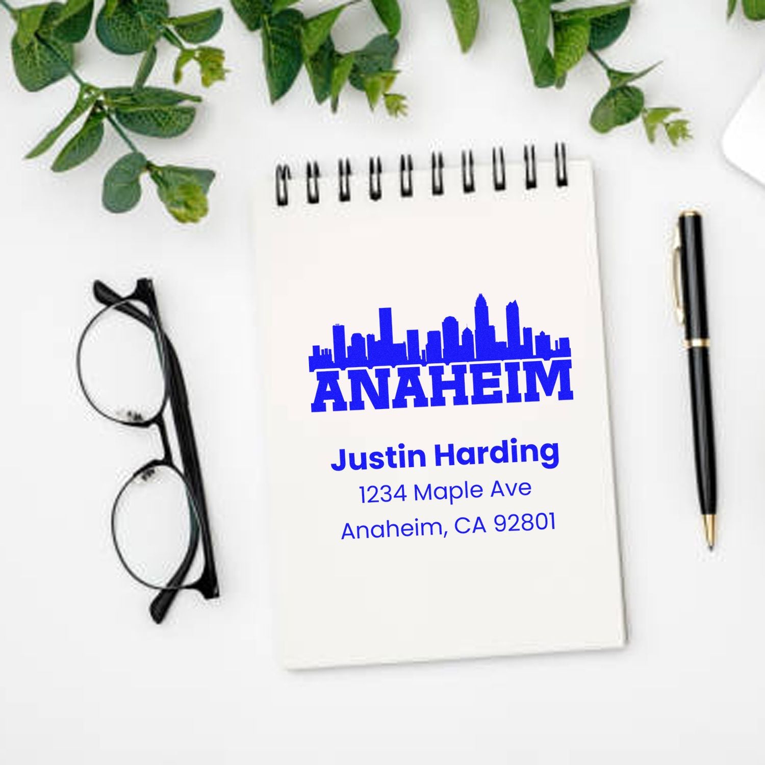 Custom Anaheim rubber stamp mockup with skyline and return address for Justin Harding, 1234 Maple Ave, Anaheim, CA 92801.
