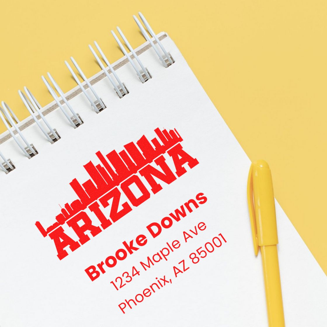 Arizona custom address rubber stamp with skyline logo and business details on notebook for branding and mailings.