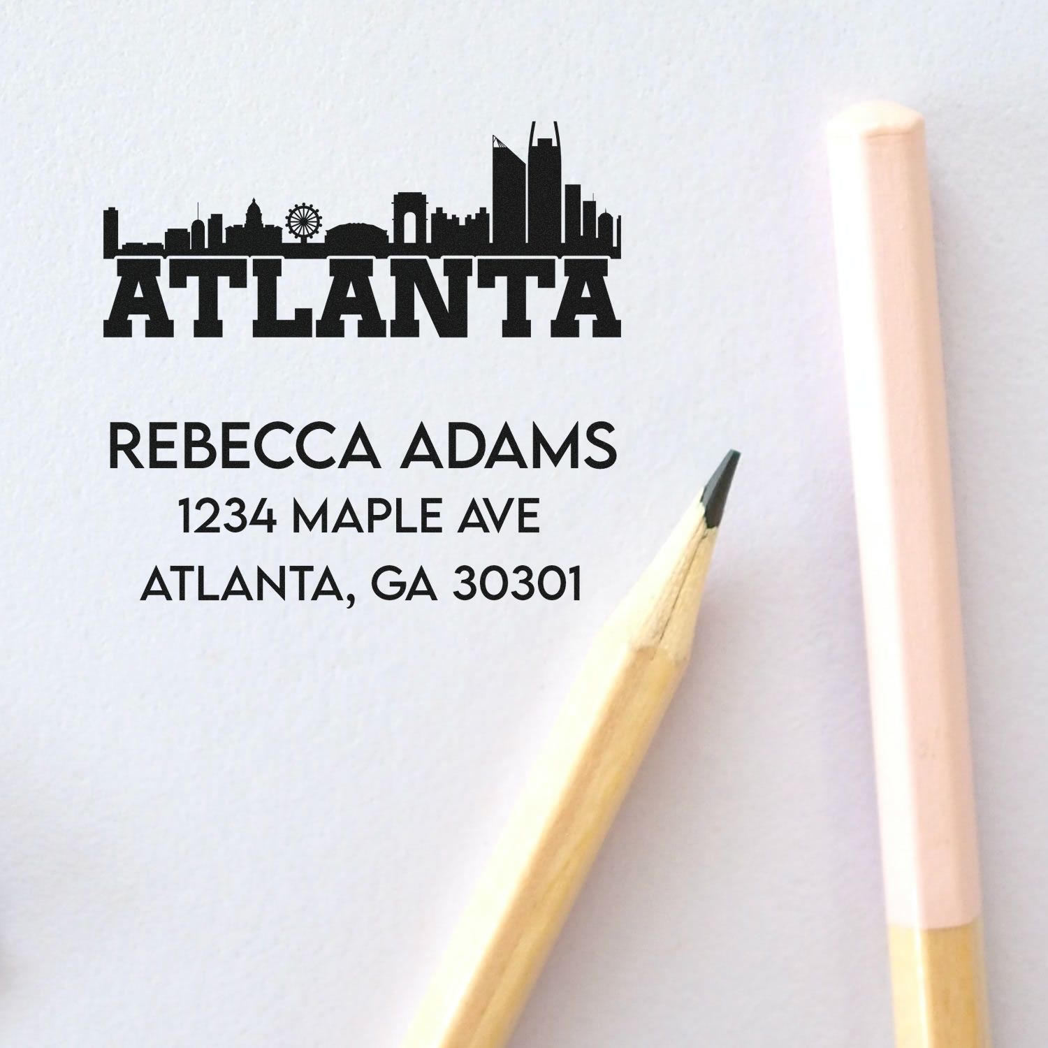 Custom Atlanta skyline rubber stamp with return address: Rebecca Adams, 1234 Maple Ave, Atlanta, GA 30301.