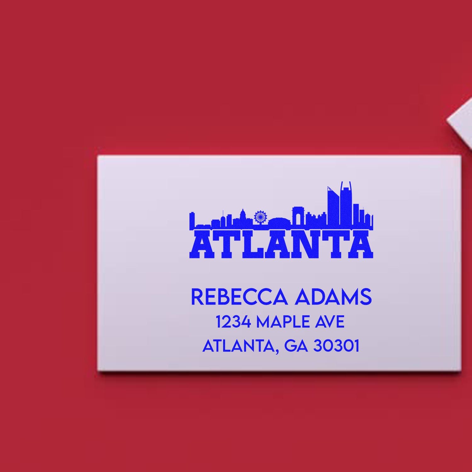 Custom Atlanta address rubber stamp with skyline design for Rebecca Adams, 1234 Maple Ave, Atlanta, GA 30301.