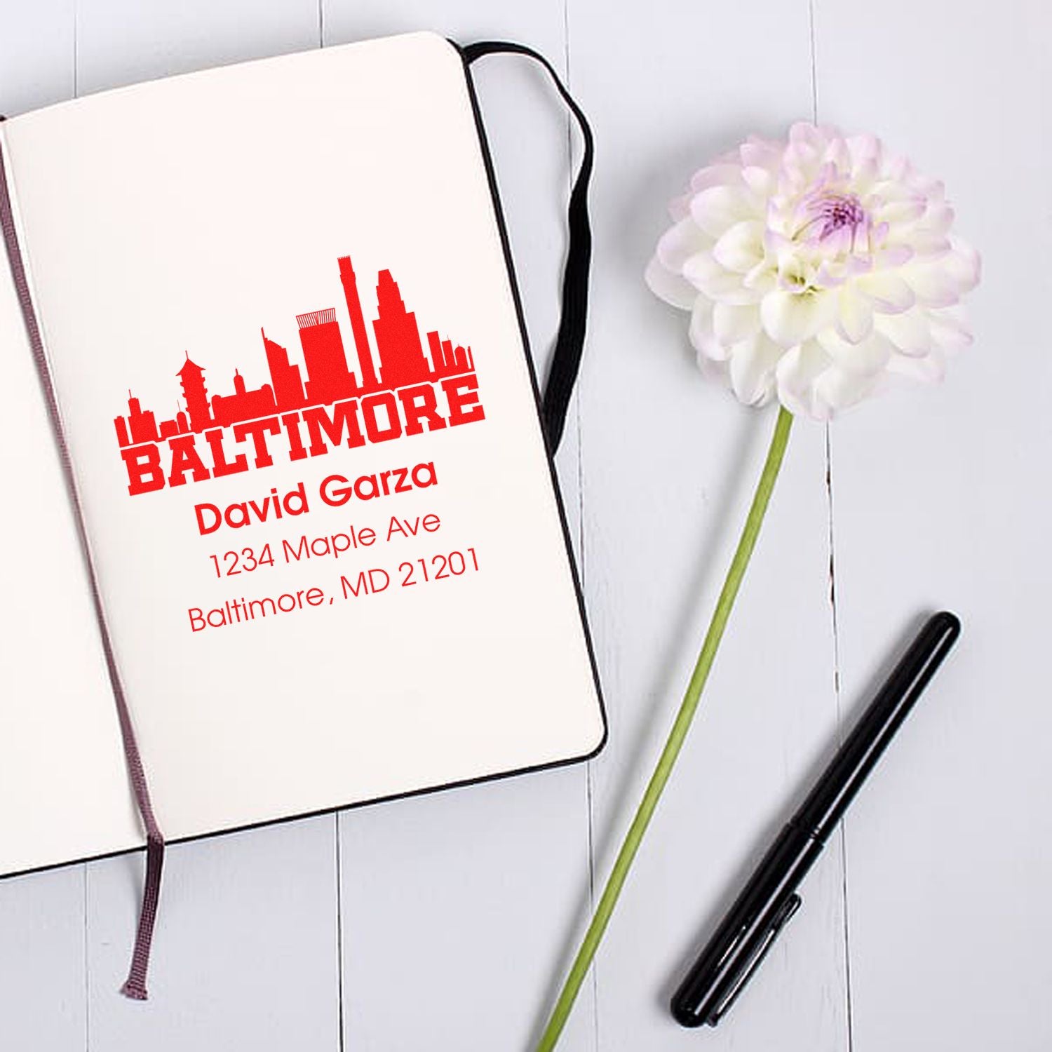 Custom Baltimore address rubber stamp on notebook with name and street address for personalized stationery.