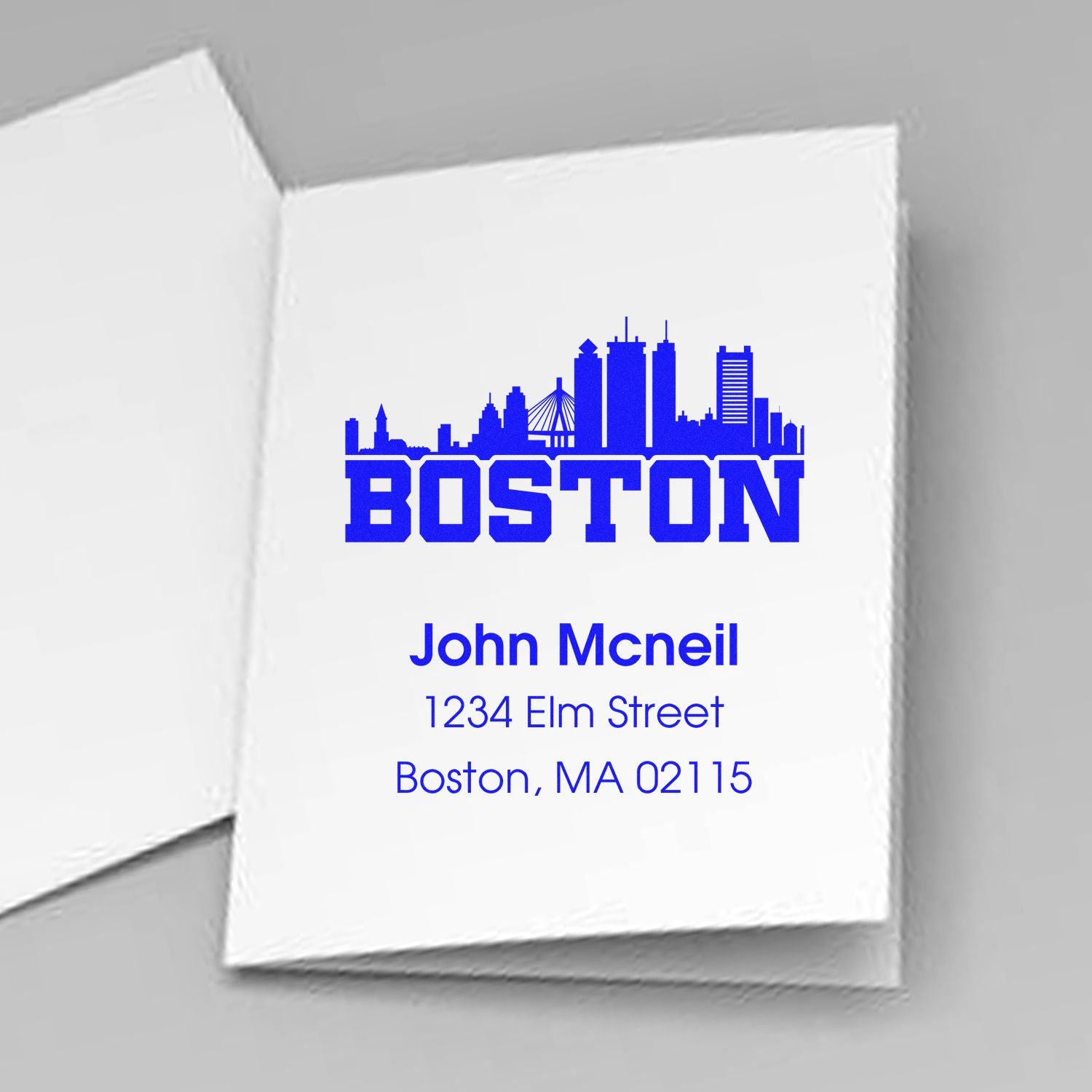 Custom Boston skyline rubber stamp with return address for John Mcneil, 1234 Elm Street, Boston, MA 02115.