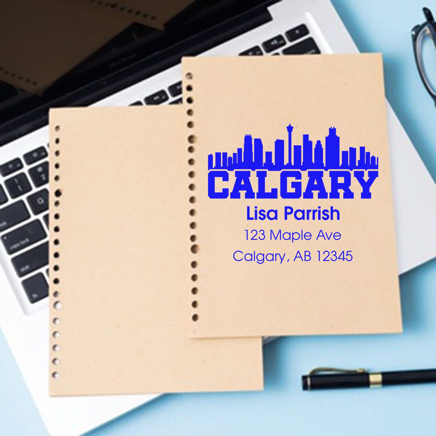 Personalized Calgary rubber stamp with skyline, name, and return address for business stationery and mailing labels.