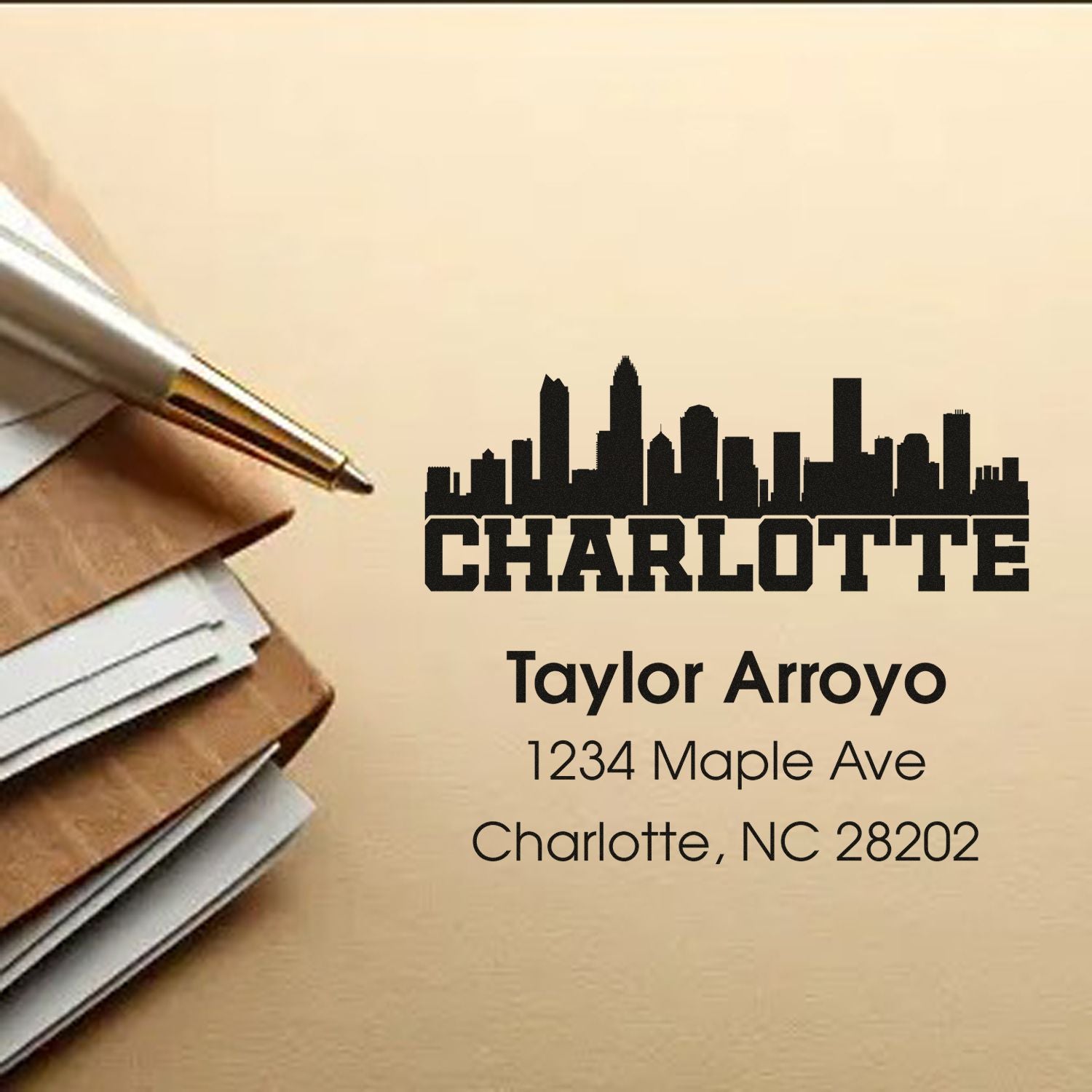 Custom Charlotte return address rubber stamp with skyline design for Taylor Arroyo, 1234 Maple Ave, Charlotte, NC 28202.