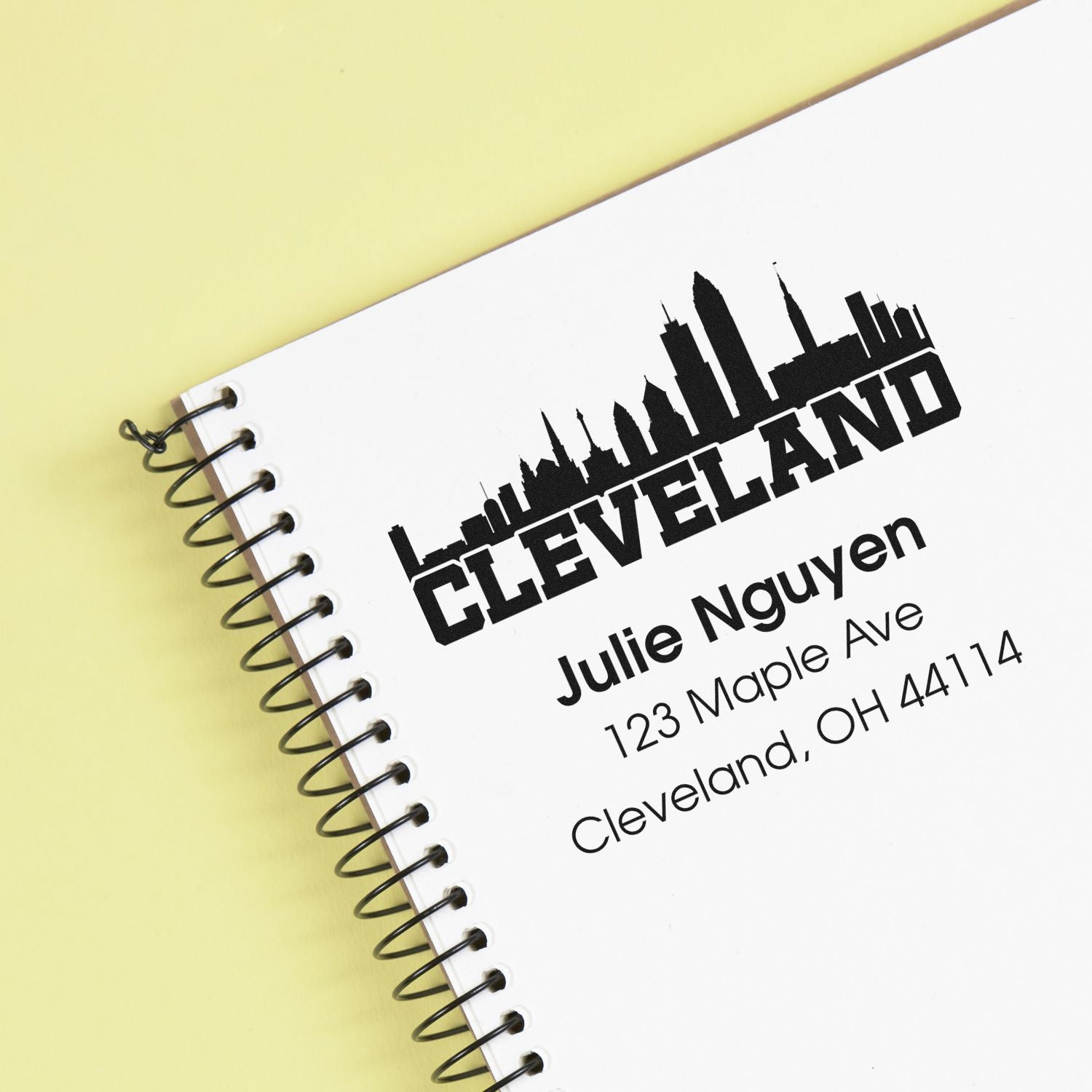 Custom Cleveland rubber stamp with skyline and return address for Julie Nguyen, 123 Maple Ave, Cleveland, OH 44114.