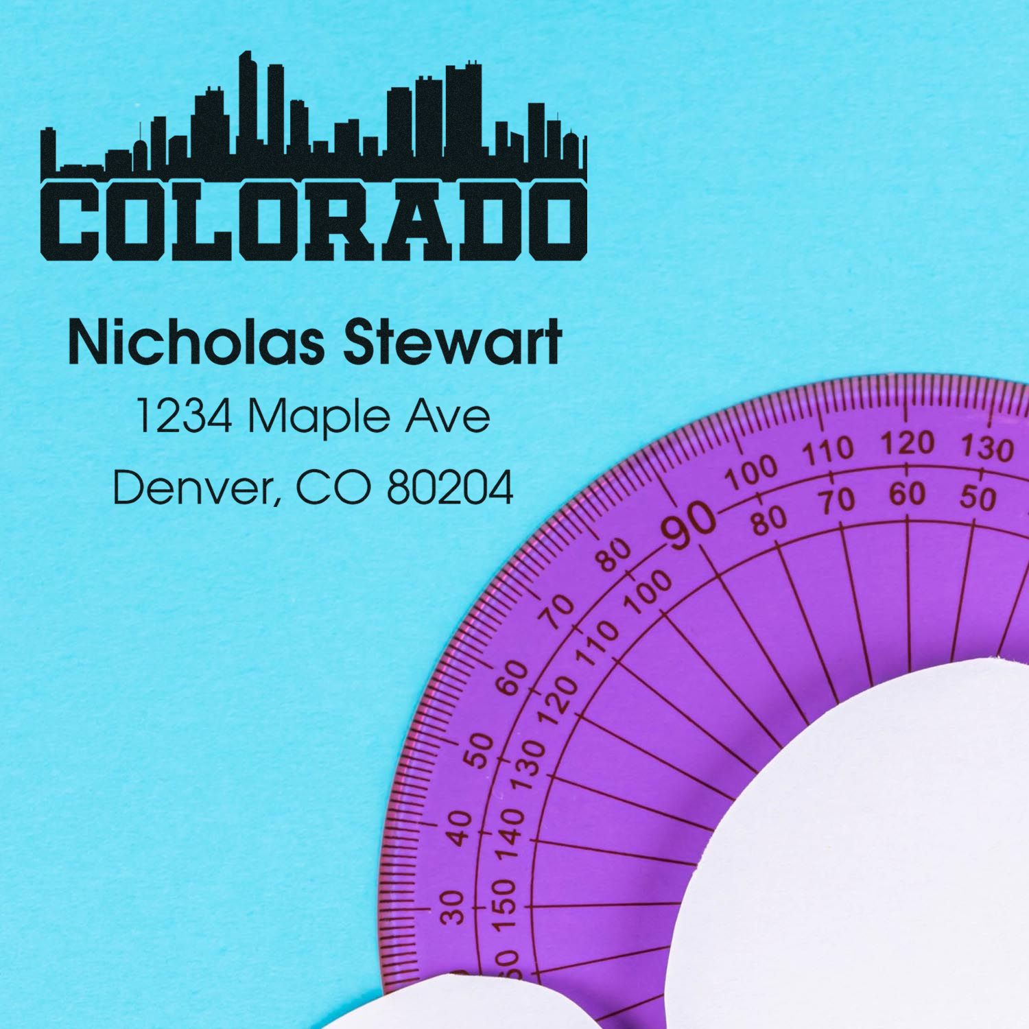 Personalized Colorado return address rubber stamp with skyline logo, Nicholas Stewart, and Denver, CO 80204.